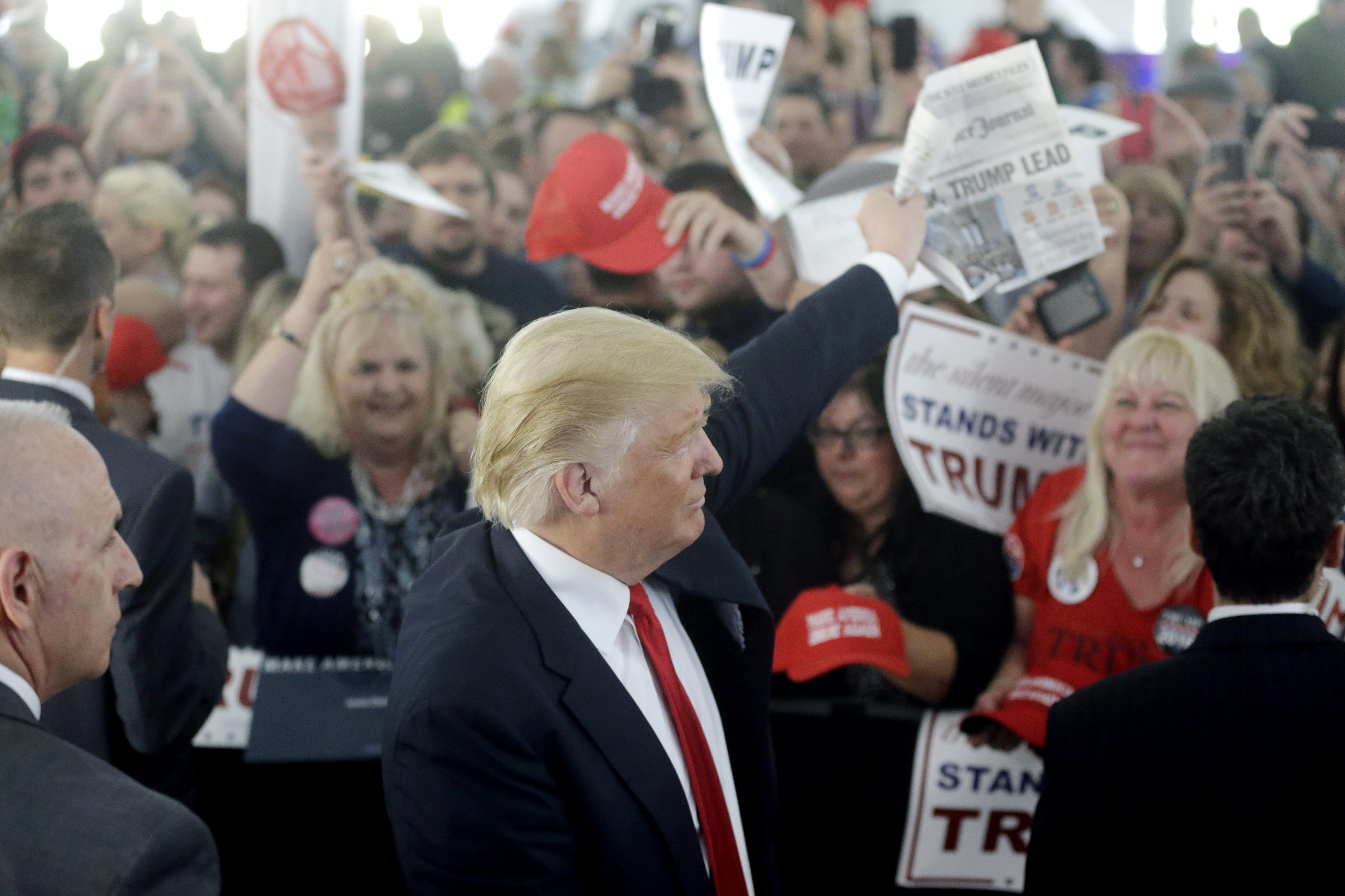 Then-Republican presidential candidate Donald Trump displayed the front page of a newspaper while greeting people in the crowd at a campaign rally in Warwick in 2016.