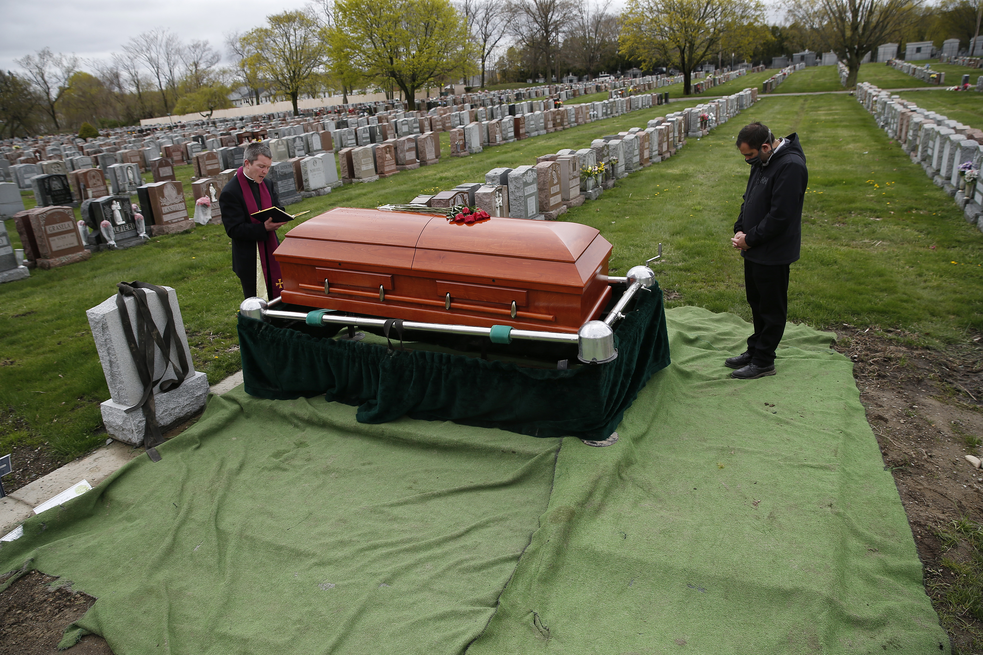 Fr. Eric Bennett prayed over the casket of a man who died of COVID-19. Because the man’s family live in Italy, where they were in lockdown, they were unable to travel here for the funeral. The only other person in attendance was funeral director Joe Ruggiero III. Under normal circumstances the man’s body would have been shipped back to Italy, but because of restrictions put into place due to coronavirus that wasn’t possible.