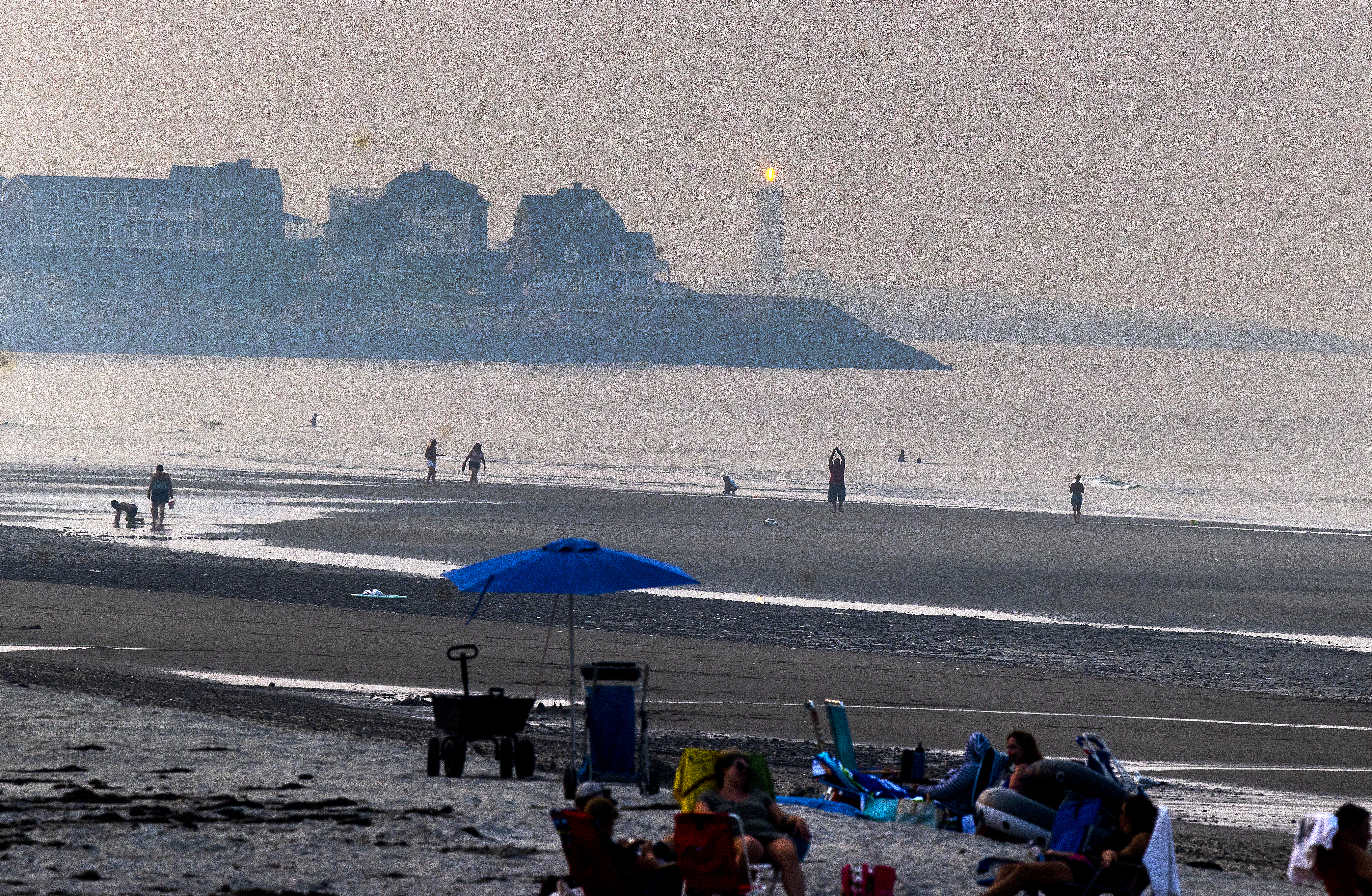 Boston Light is visible in the haze over Nantasket Beach in Hull.