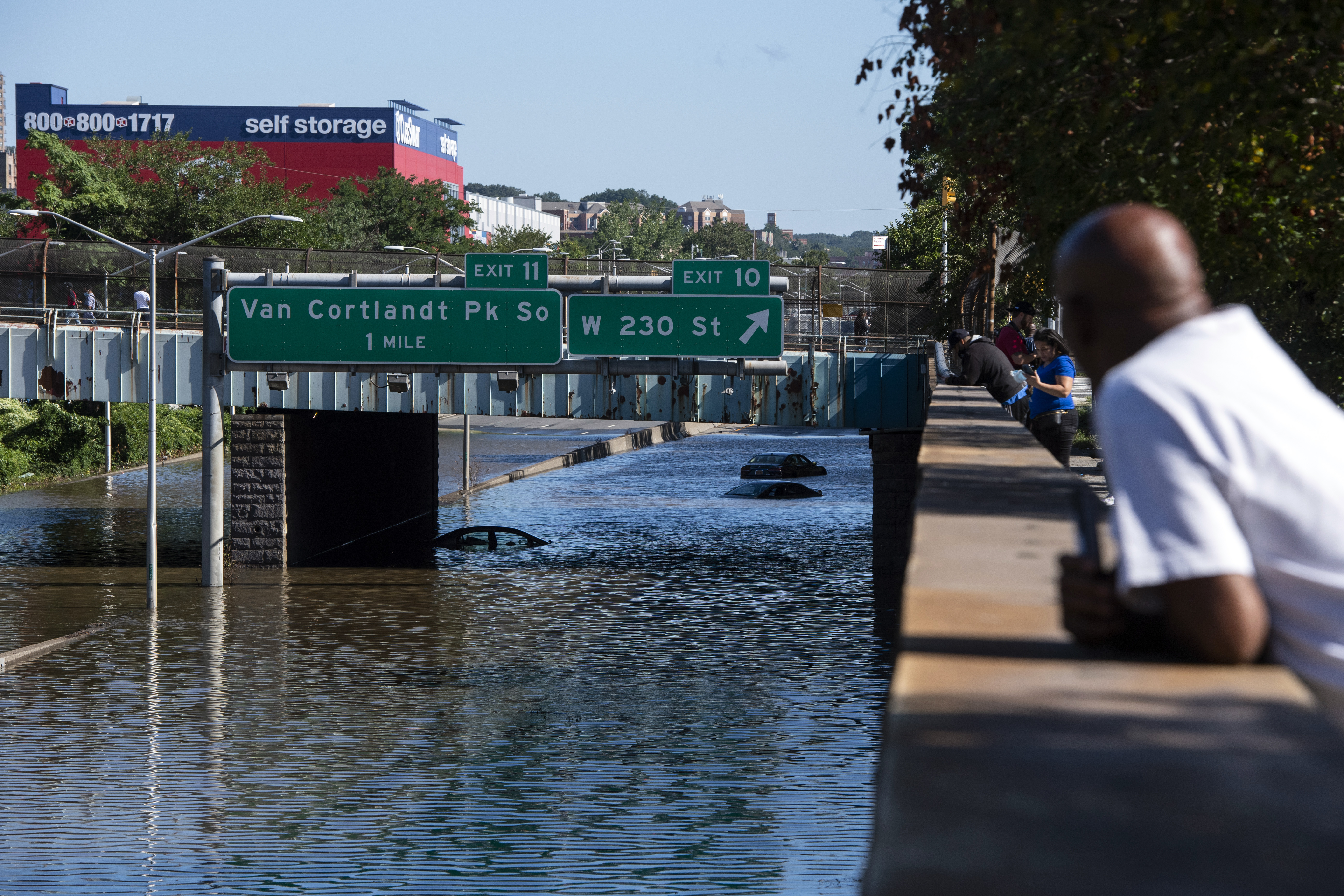 Onlookers in the Bronx surveyed the floodwaters inundating Interstate Highway 87, also known as the Major Deegan Expressway, on Thursday morning.