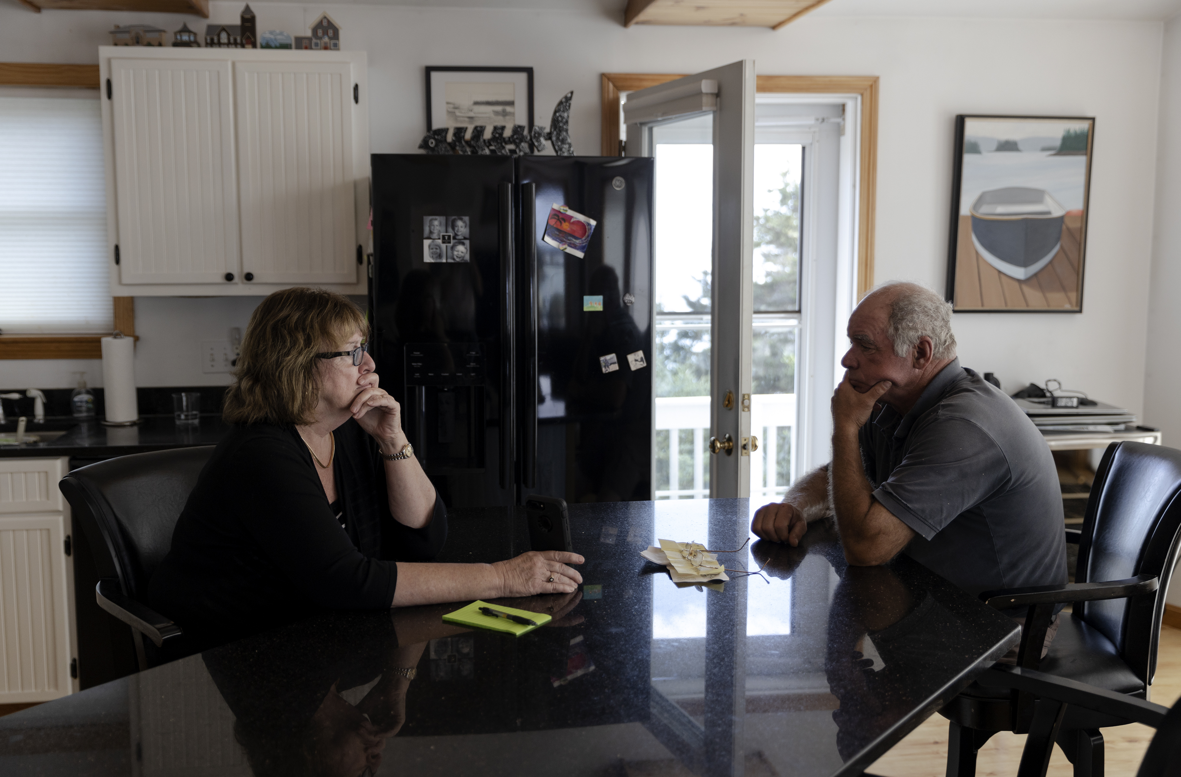Jean Thompson held out her phone so her husband, Frankie, could hear Mike Yohe, the CEO of Lobster 207, during a call at their home on Sept. 3 about the closure of 1,000 square miles of federal fishing waters.