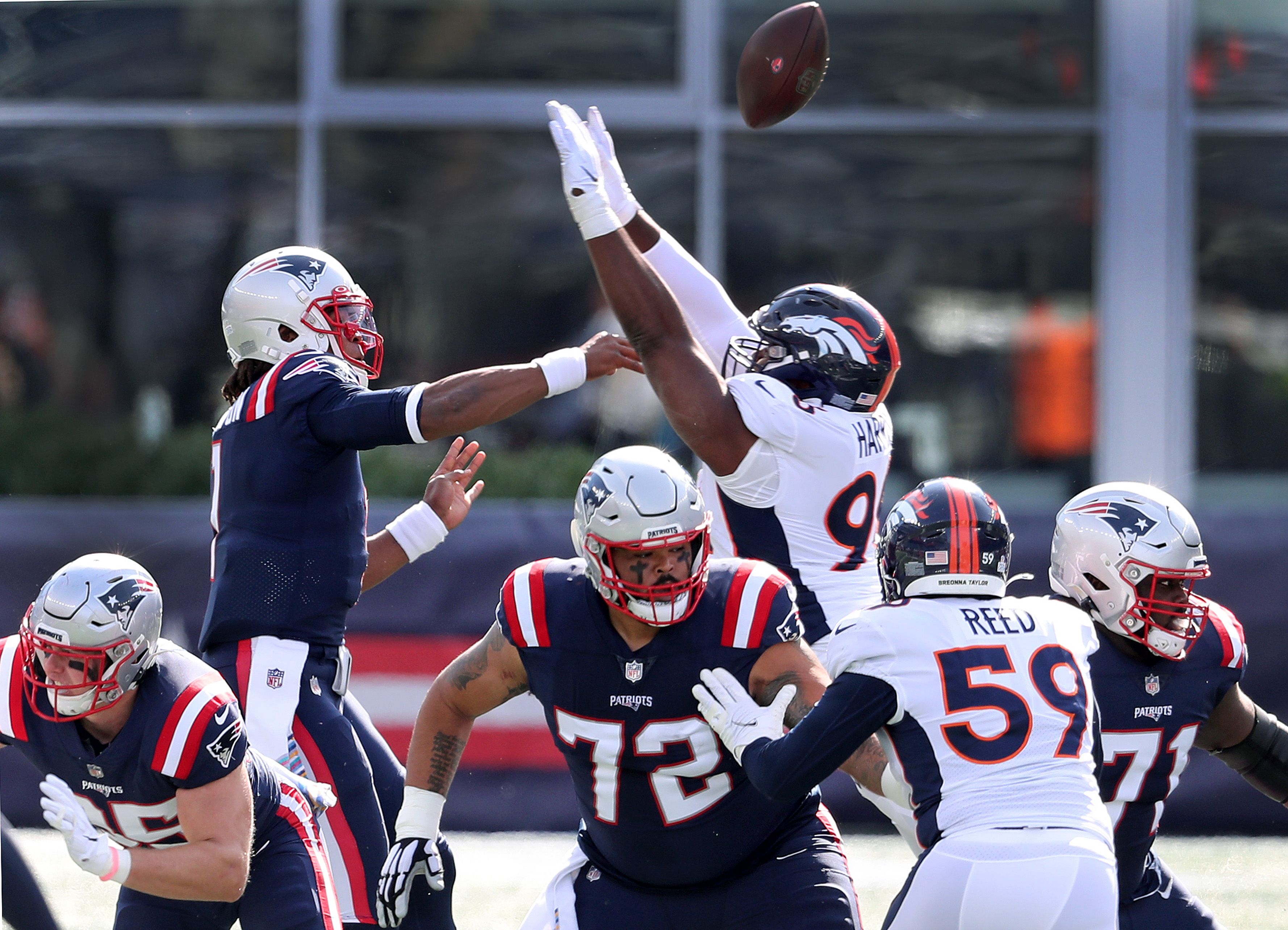 Cam Newton's first pass attempt of the game is deflected by the Broncos' Shelby Harris. DeShawn Williams scooped it up for an interception.