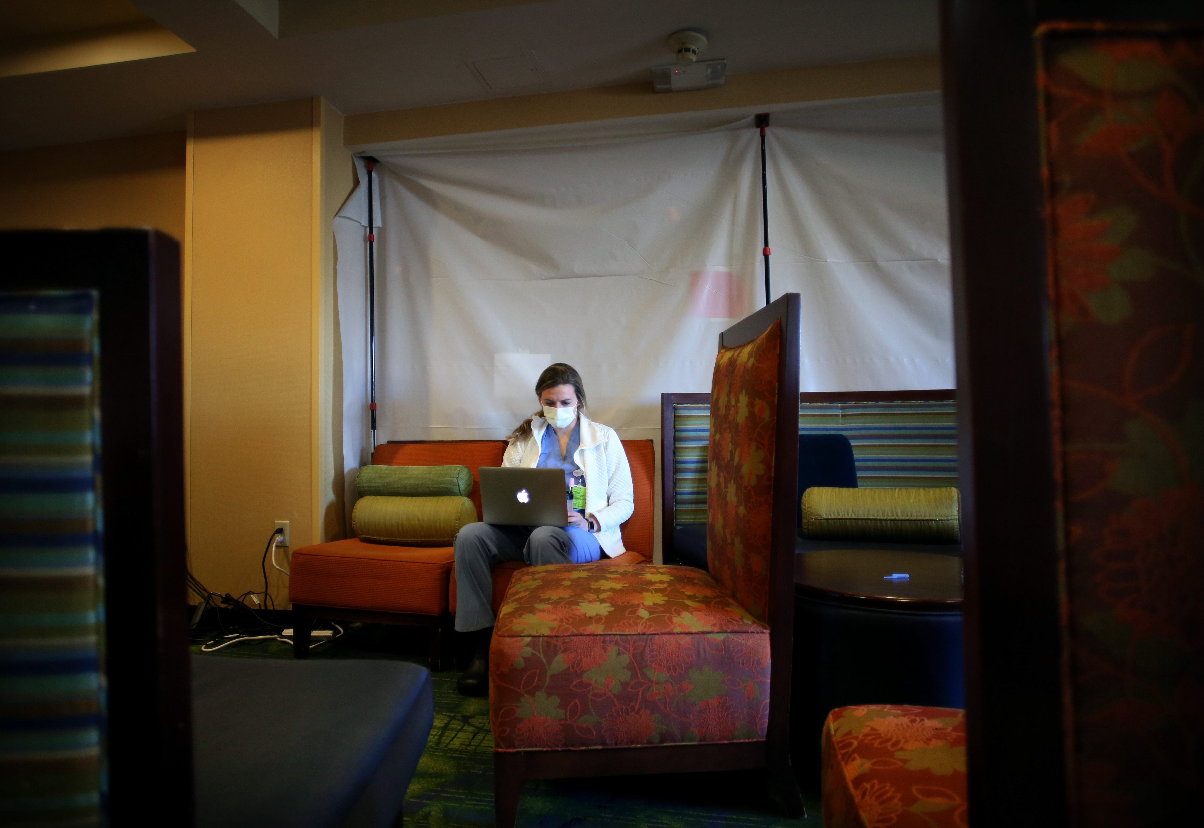 Revere, MA - 5/8/2020: Physician assistant Meagan Murtagh works in the nurses station at a Quality Inn that has been converted into a non-congregate shelter in Revere, MA on May 08, 2020. The Quality Inn in Revere has been converted into a non-congregate shelter to house positive Covid-19 patients that need a place to recover.  (Craig F. Walker/Globe Staff)