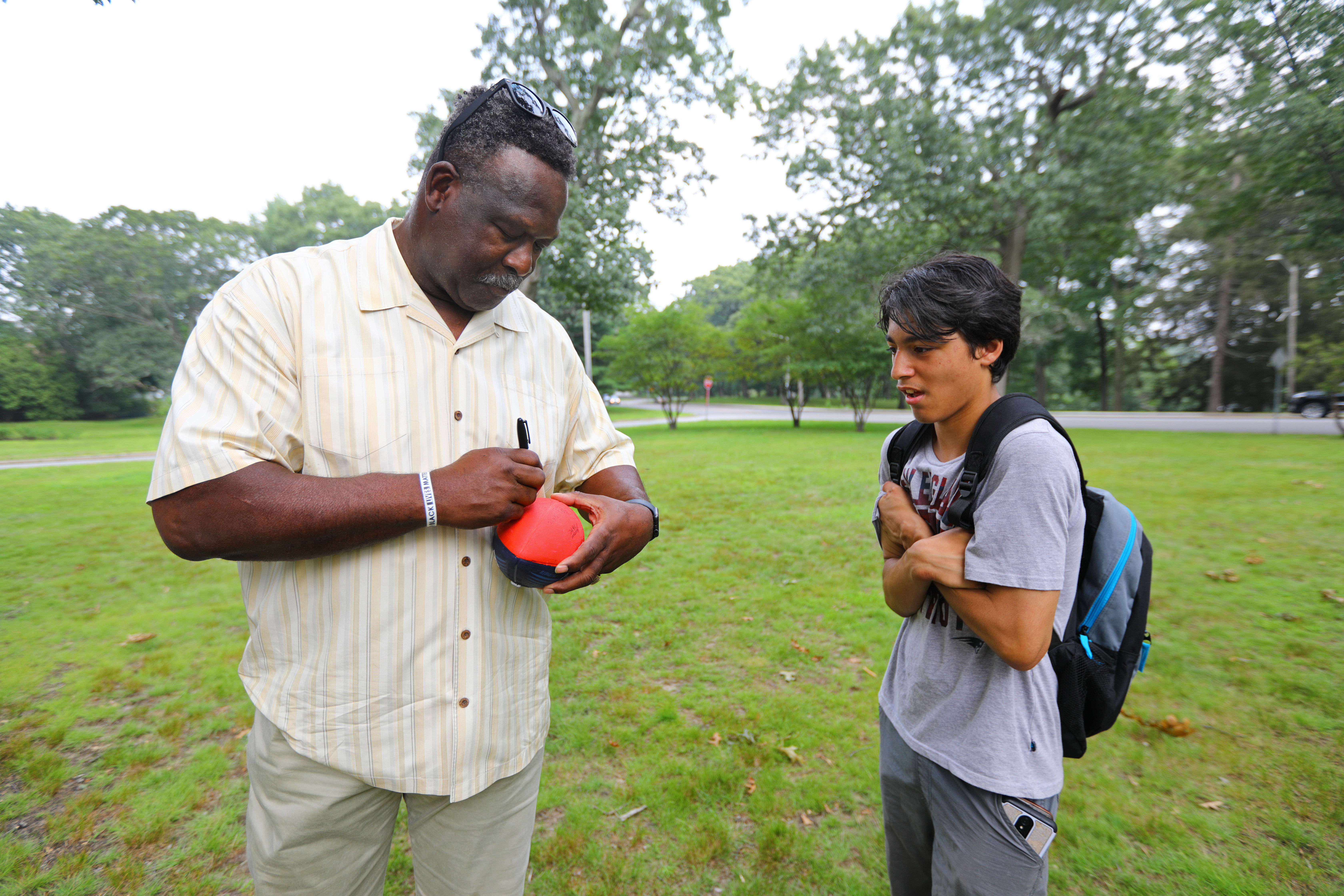 Patriots Pro Football Hall of Famer Andre Tippett autographed a ball for 14-year-old Antonio during a Patriots Foundation event in Providence.
