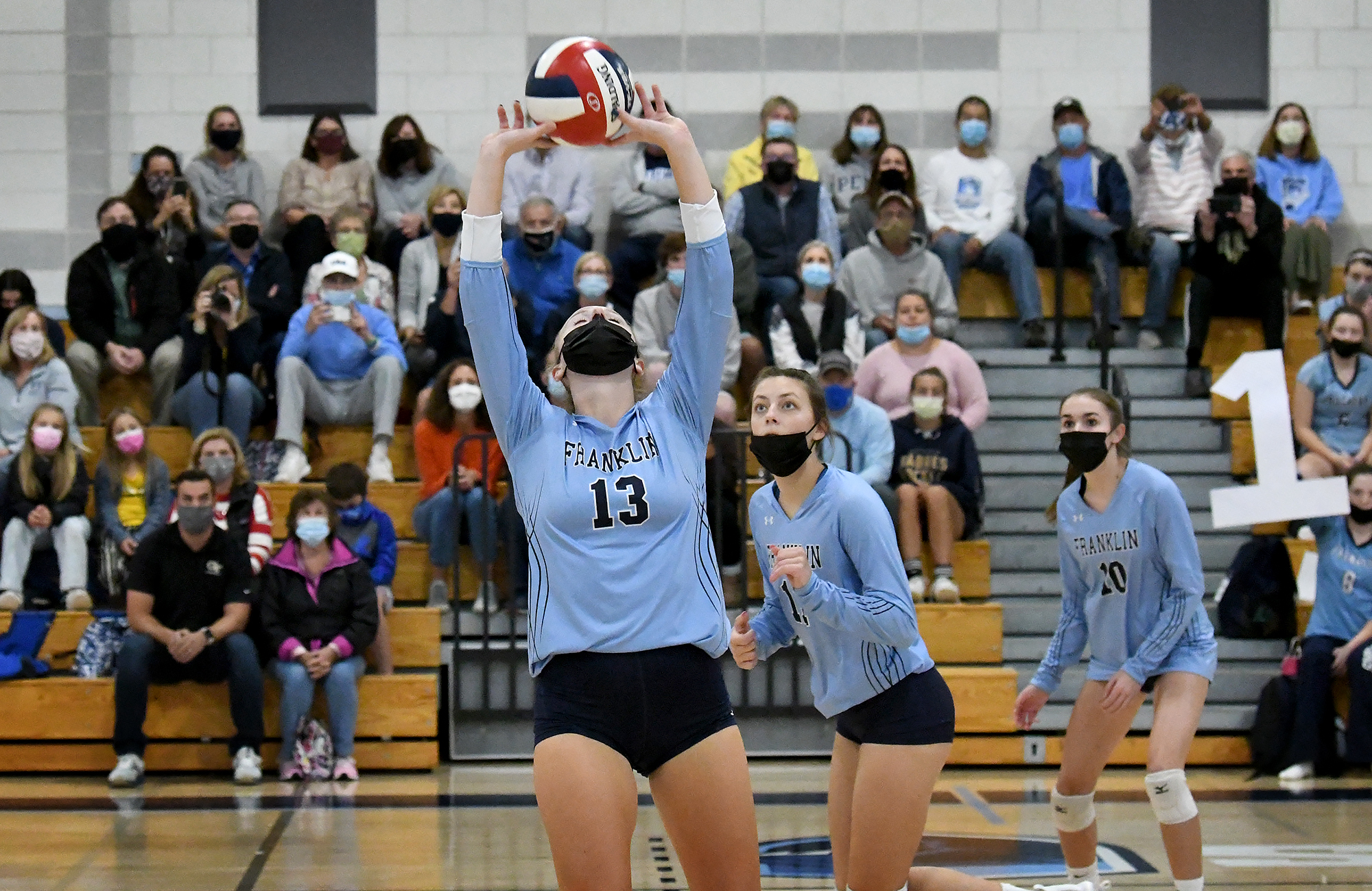 Senior captain Cailyn Mackintosh sets the ball for her 1,000th career assist.