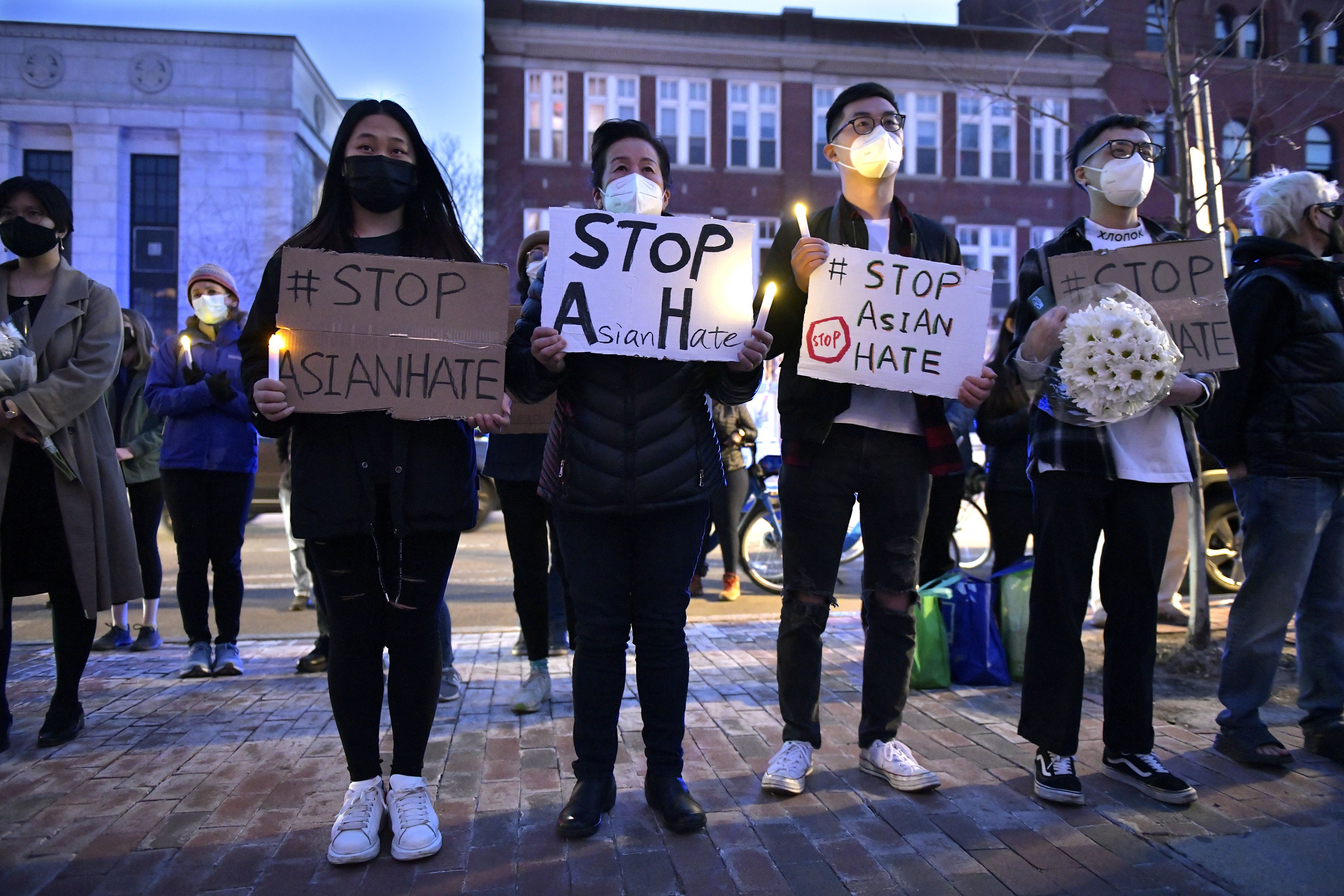 From left, Cambridge residents Keira Lei, Grace Gong, Alan Ran, and Song Feng, during a Stop Asian Hate rally at Cambridge City Hall on March 21, 2021.