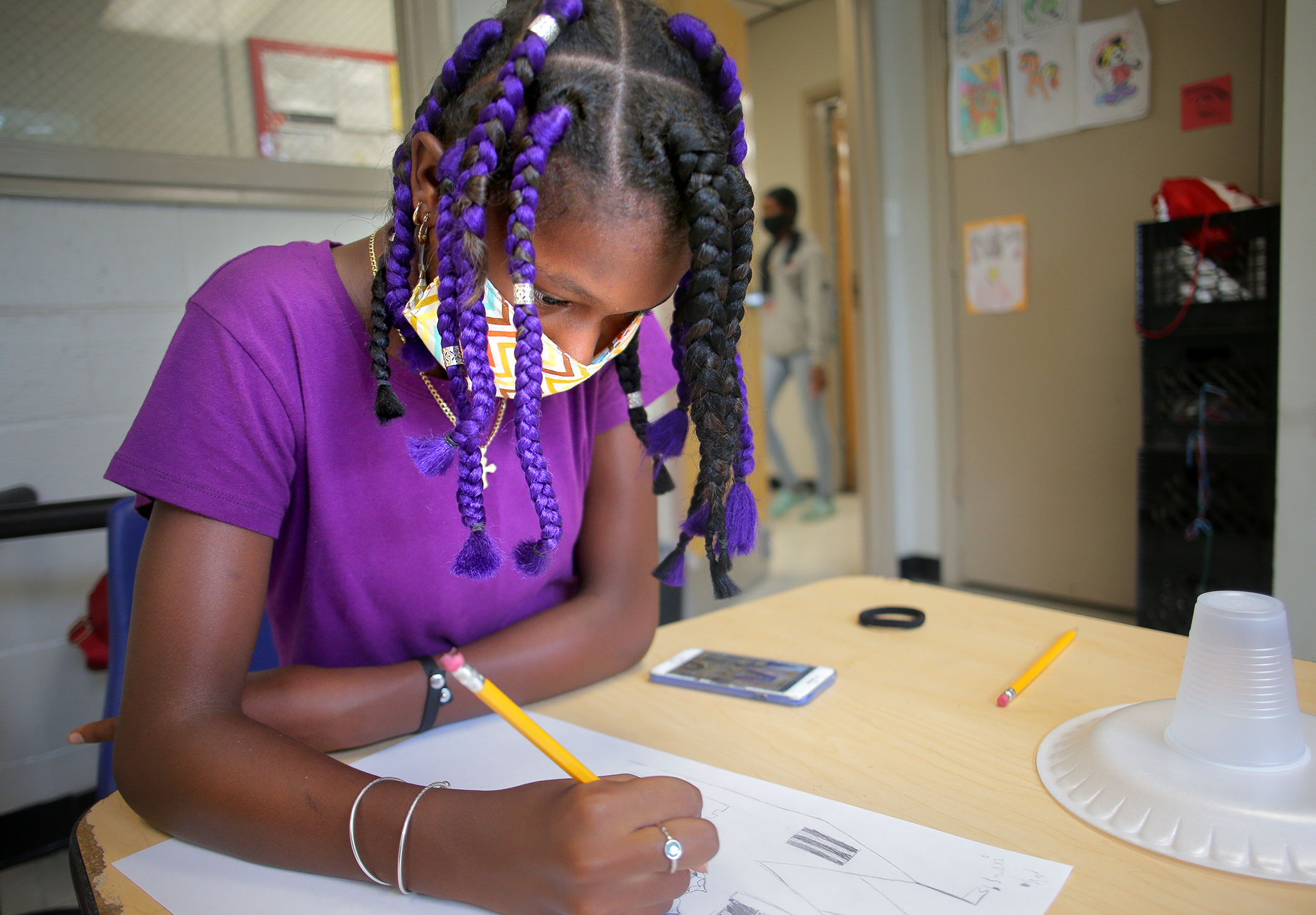 Surraya Burton, 12, worked on a drawing at the Dorchester YMCA.