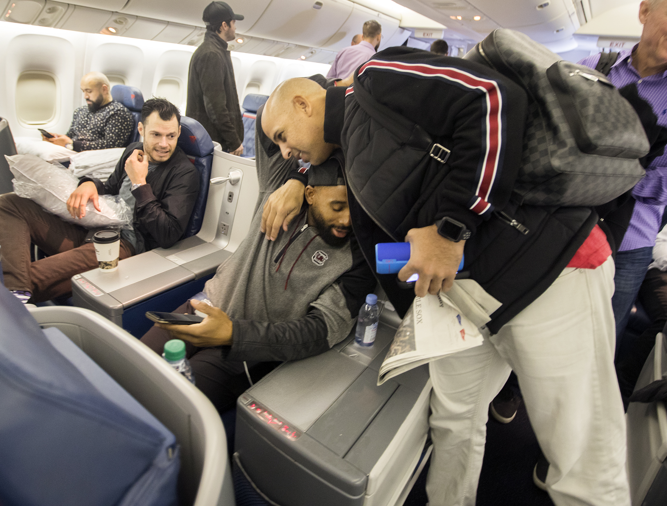 Alex Cora hugs Jackie Bradley Jr. on the Red Sox charter flight home after the 2018 World Series.