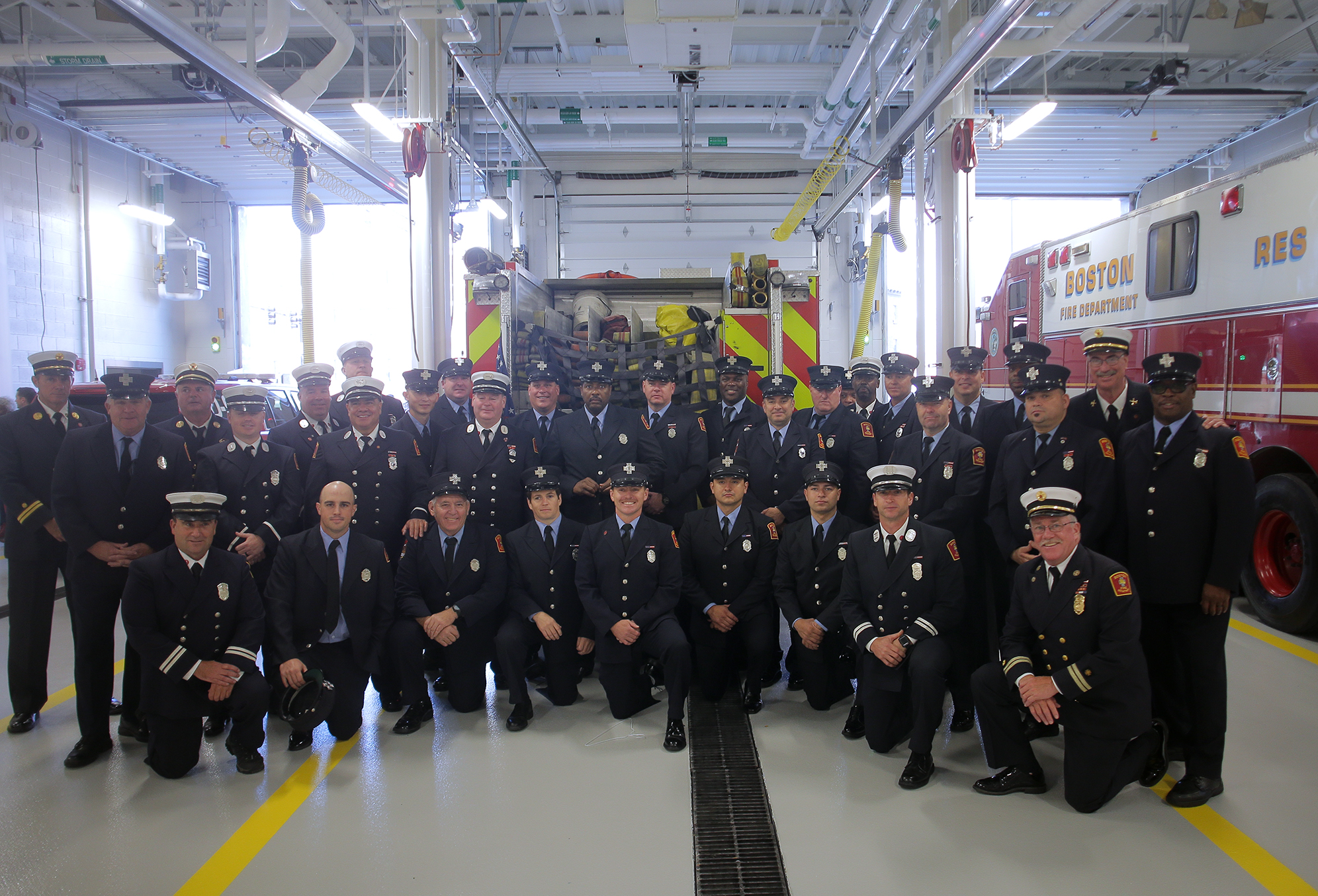 Firefighters who will work in the new station gathered for a picture in the apparatus bay.