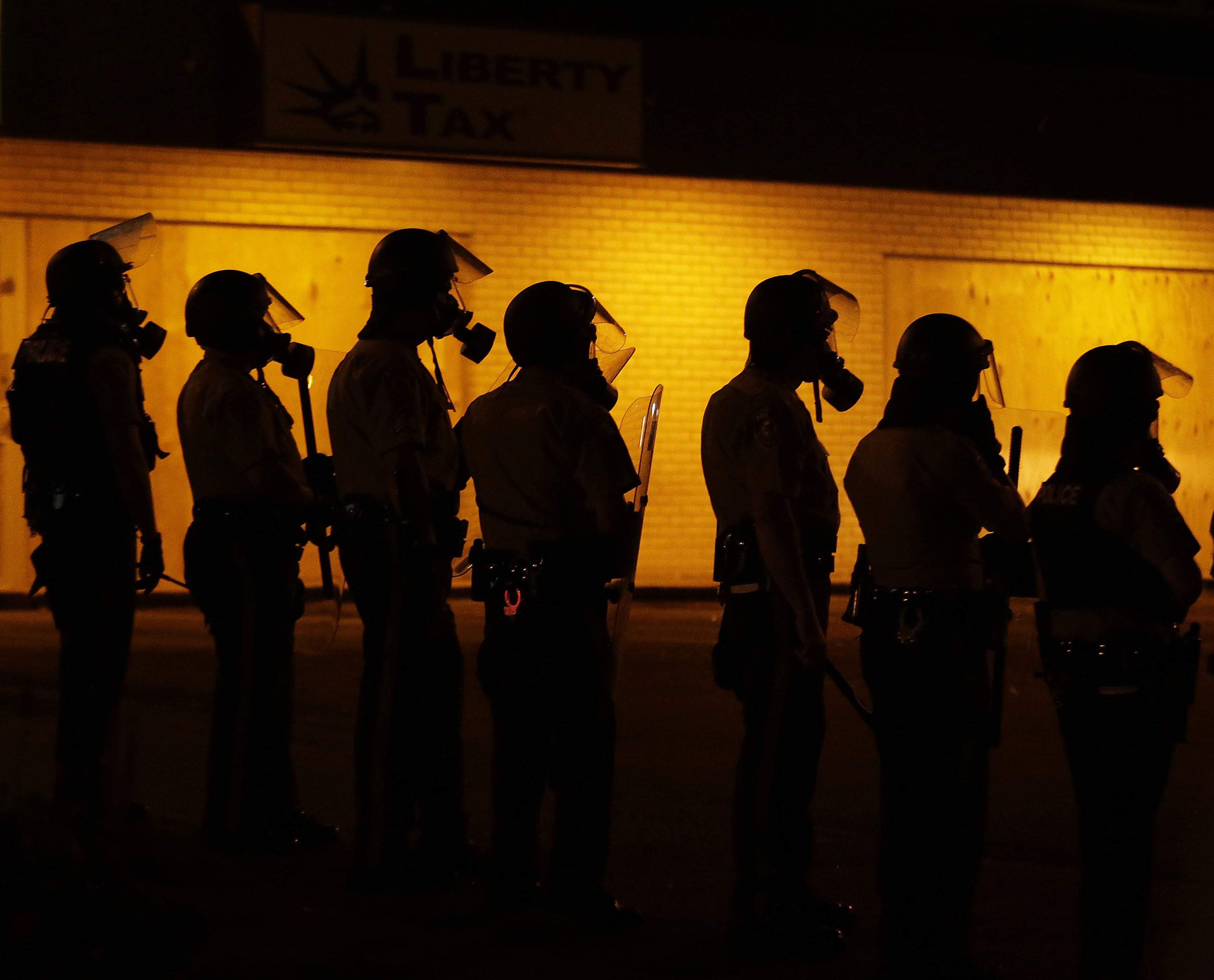 Police waited to advance after tear gas was used to disperse a crowd during a protest for Michael Brown, who was killed by a police officer Aug. 9, 2014 in Ferguson, Mo.