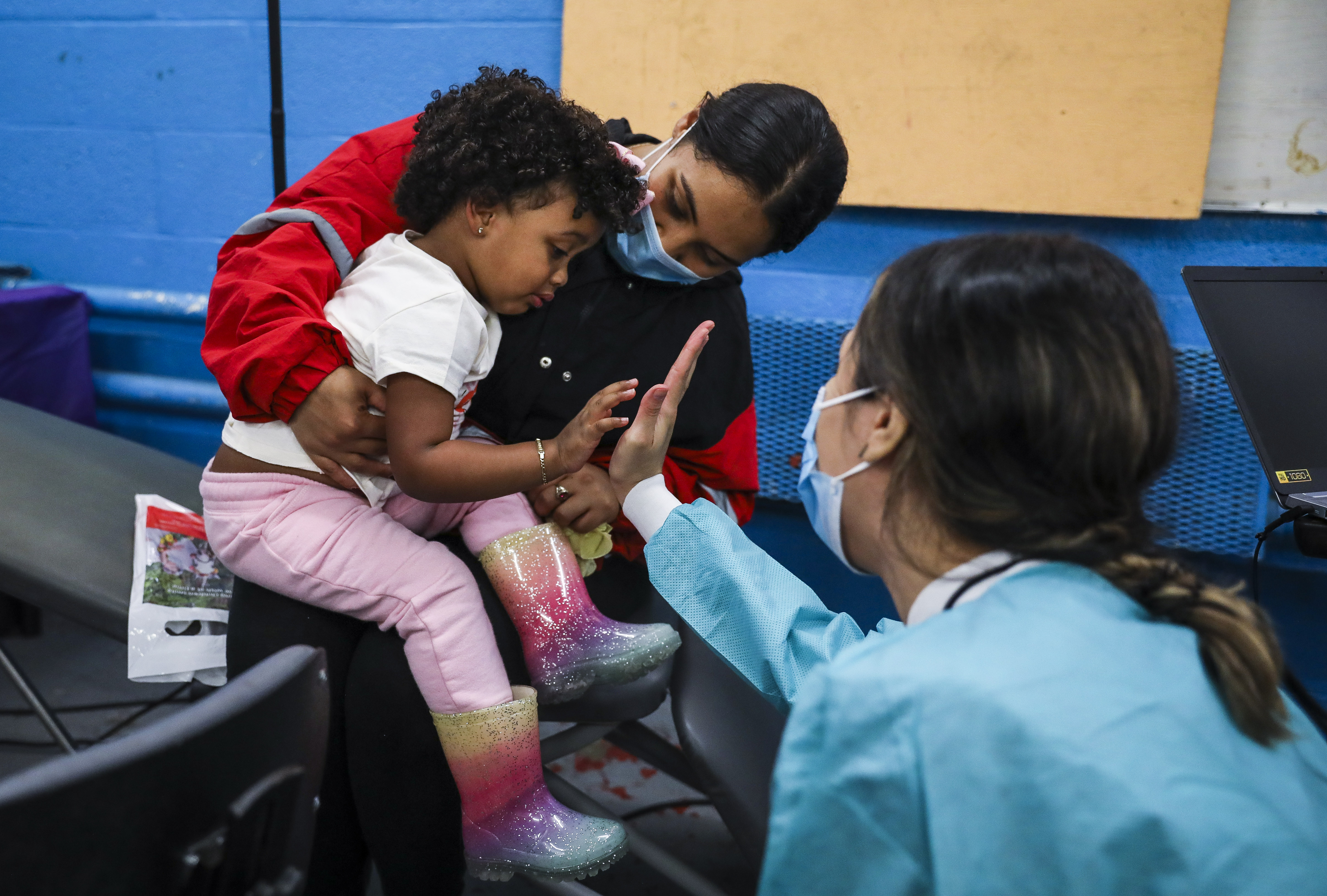 Grace Duran watched as her 2-year-old daughter, Emma Alvarez, gave a high five to ForsythKids dentist Helen Nguyen after her dental examination.