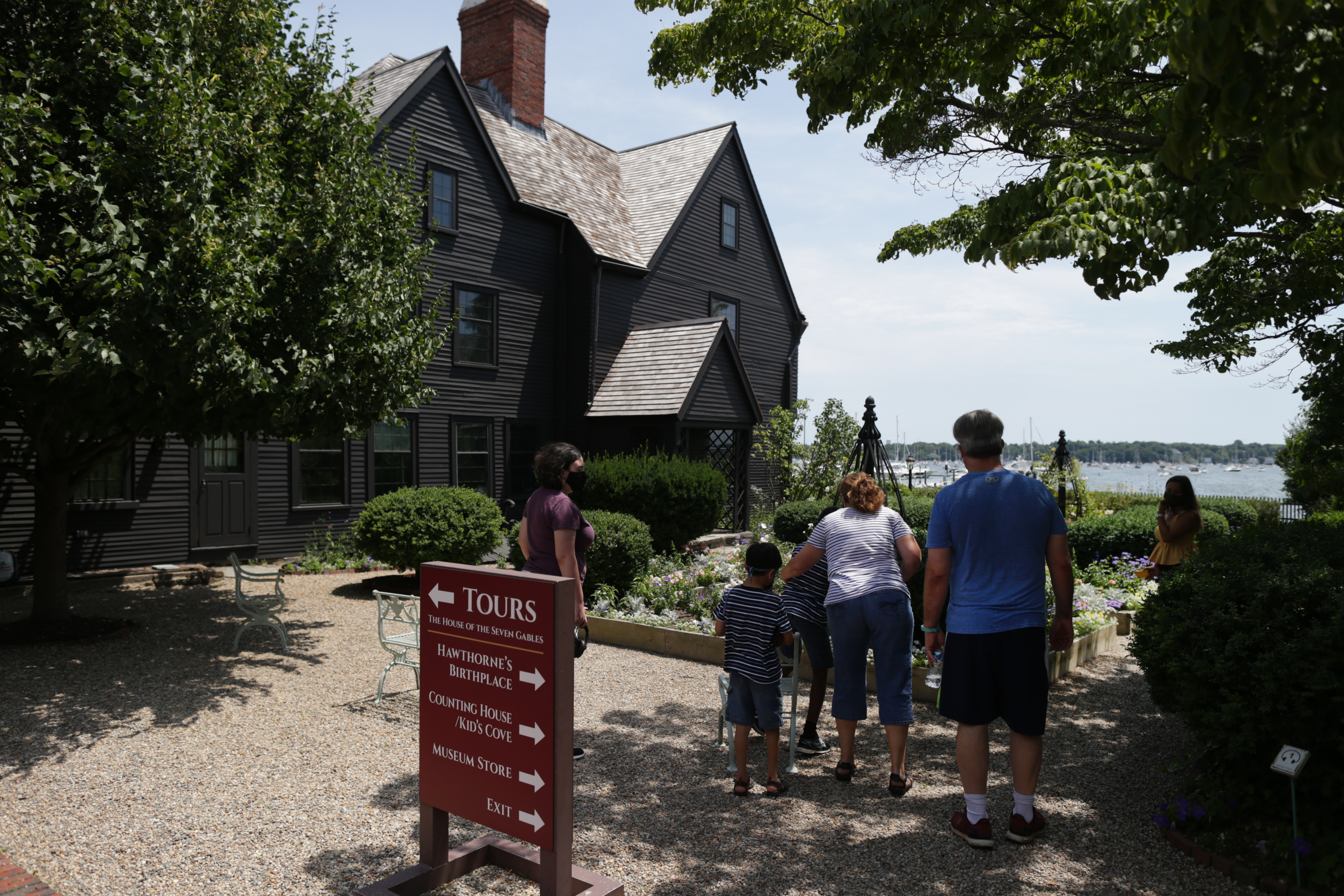 Visitors stroll in the garden of the House of the Seven Gables in Salem.