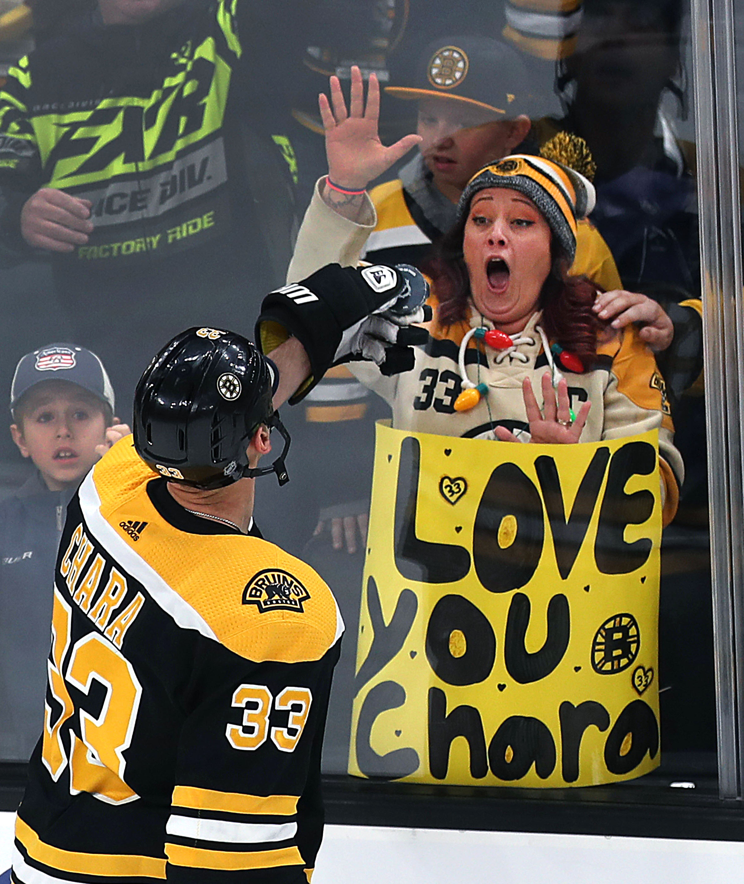 Bruins captain Zdeno Chara held a puck up to an admiring fan during pregame warmups before the Bruins’ 3-2 loss to the New York Islanders on Dec. 19 at TD Garden.