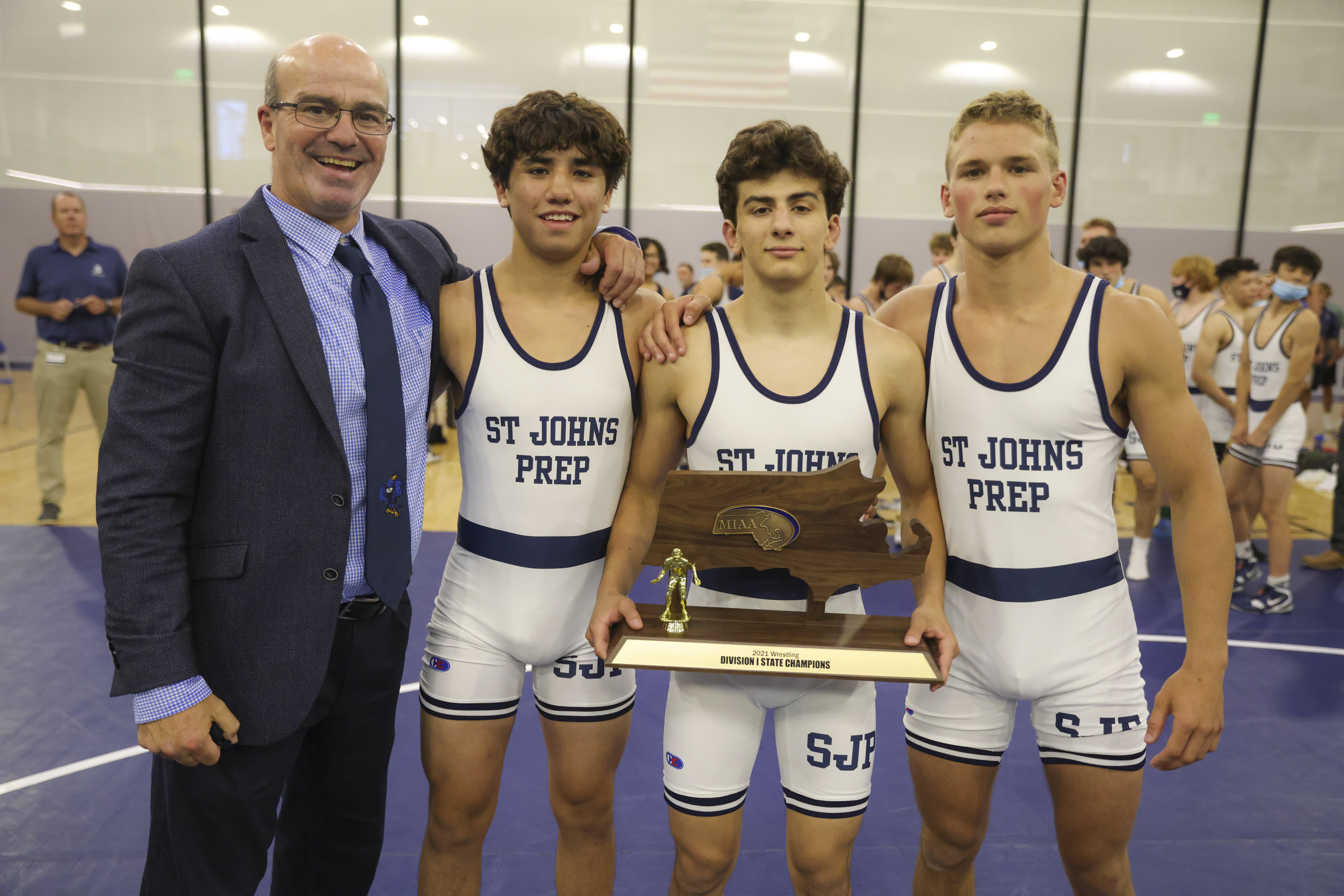 Left to right: St. John's Prep head coach Manny Costa, Adam Schaeublin, Nick Curley, and Rawson Iwanicki after a dominant win over New Bedford