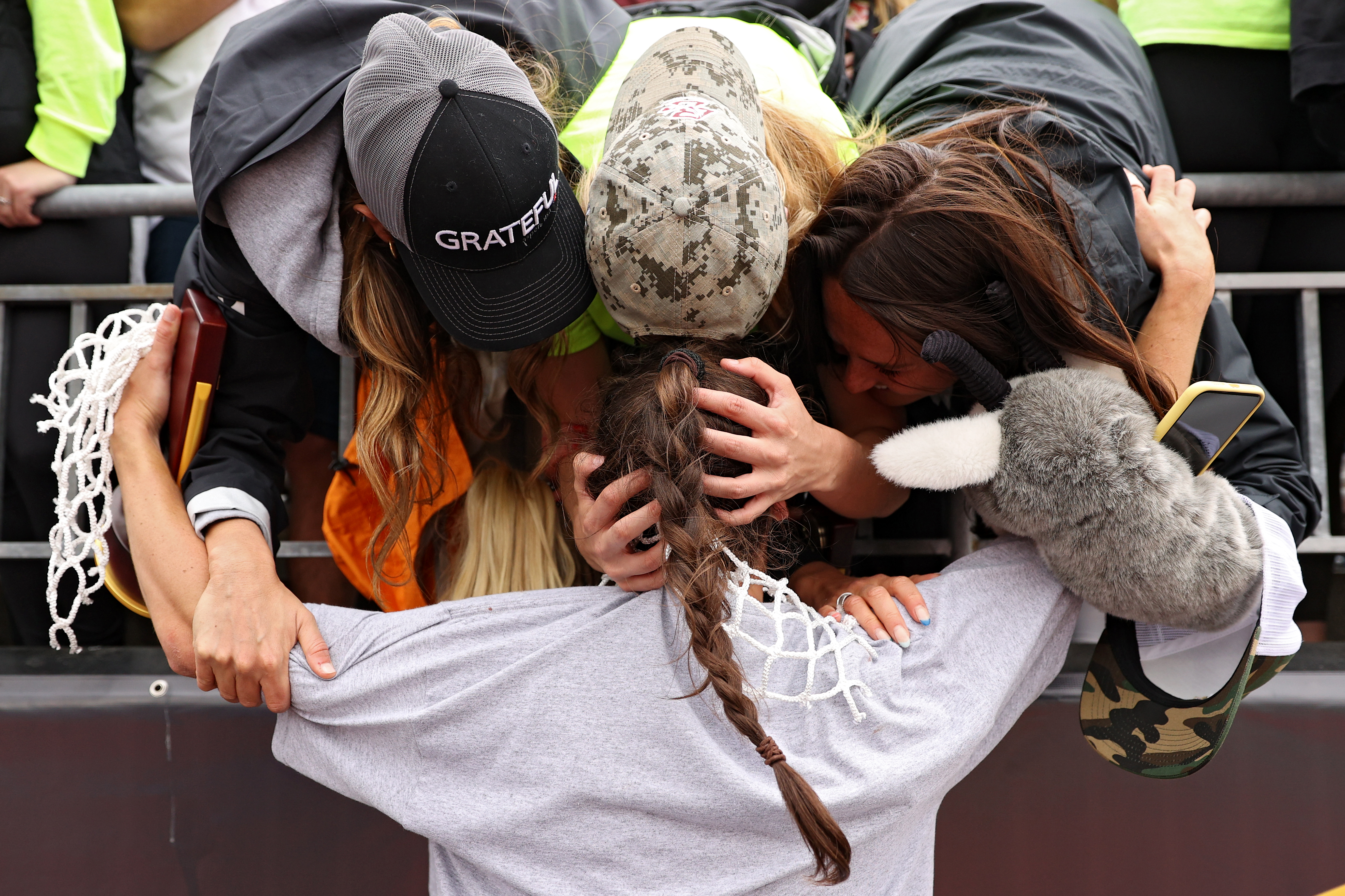 Charlotte North gets hugs from fans following her six-goal performance, which led Boston College to its first championship.