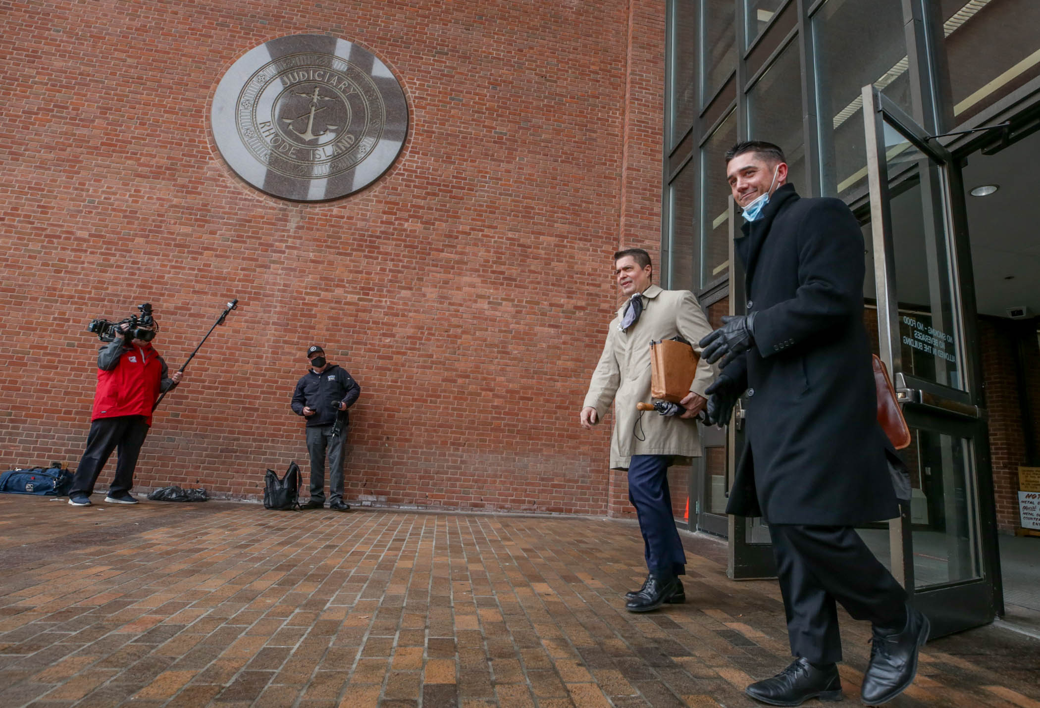 Assistant Attorney General Daniel Guglielmo, left, and Special Assistant Attorney General Michael McCabe leave the courthouse on March 18 after Providence Police Sgt. Joseph Hanley III was found guilty Thursday of simple assault on a handcuffed Providence man last April.