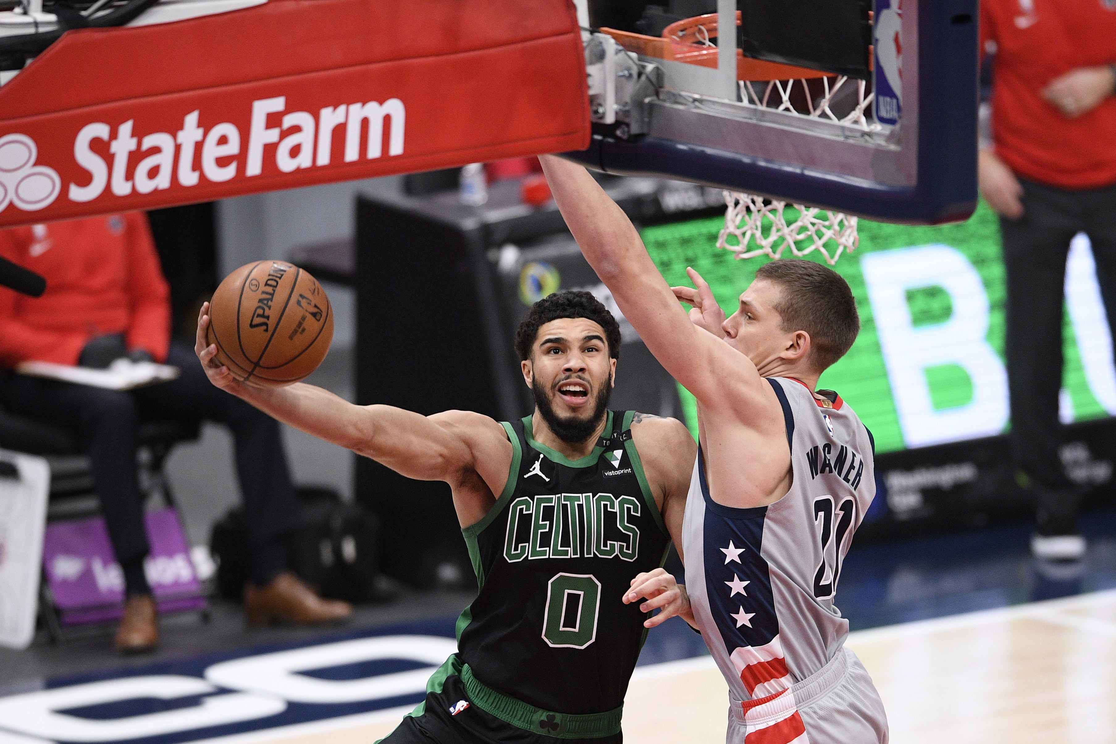 Jayson Tatum goes to the basket against Washington's Moritz Wagner in the first half of Sunday's game.