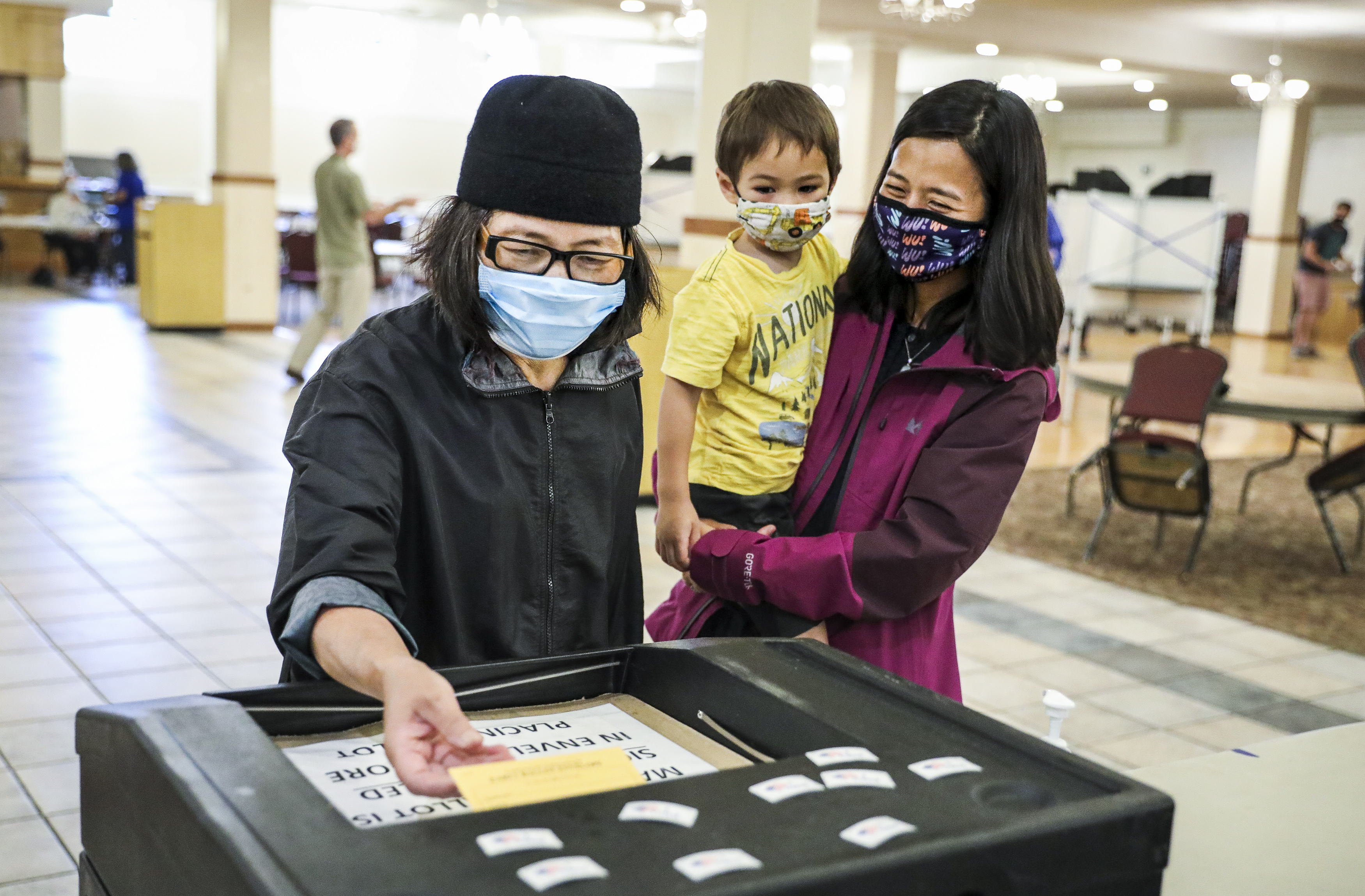 Michelle Wu, with her son Cass, accompanied her mother, Yu-Min Wu, as she voted.