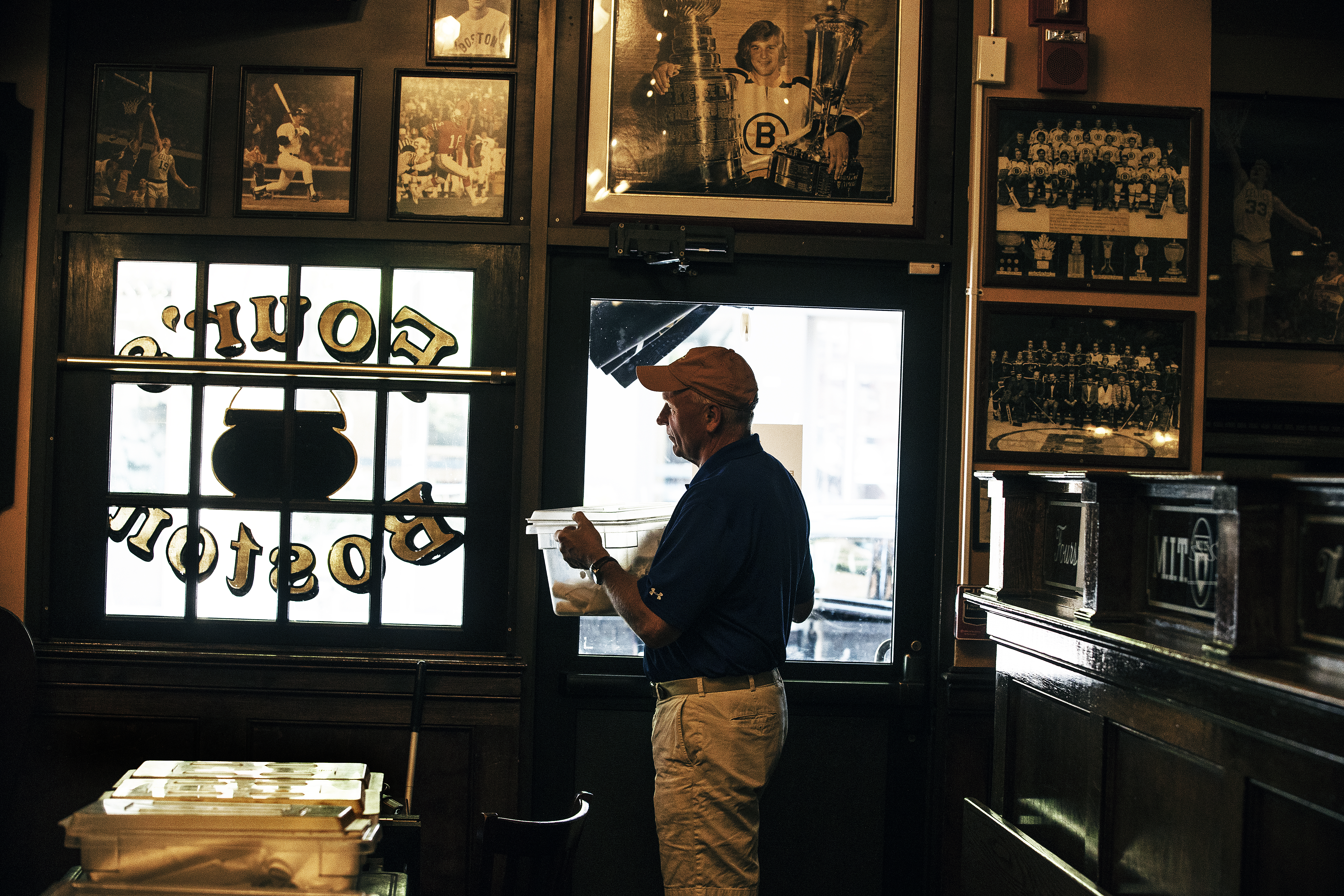 Peter Colton, the owner of The Fours, straightens up on Labor Day, a week after the sports-themed restaurant closed.