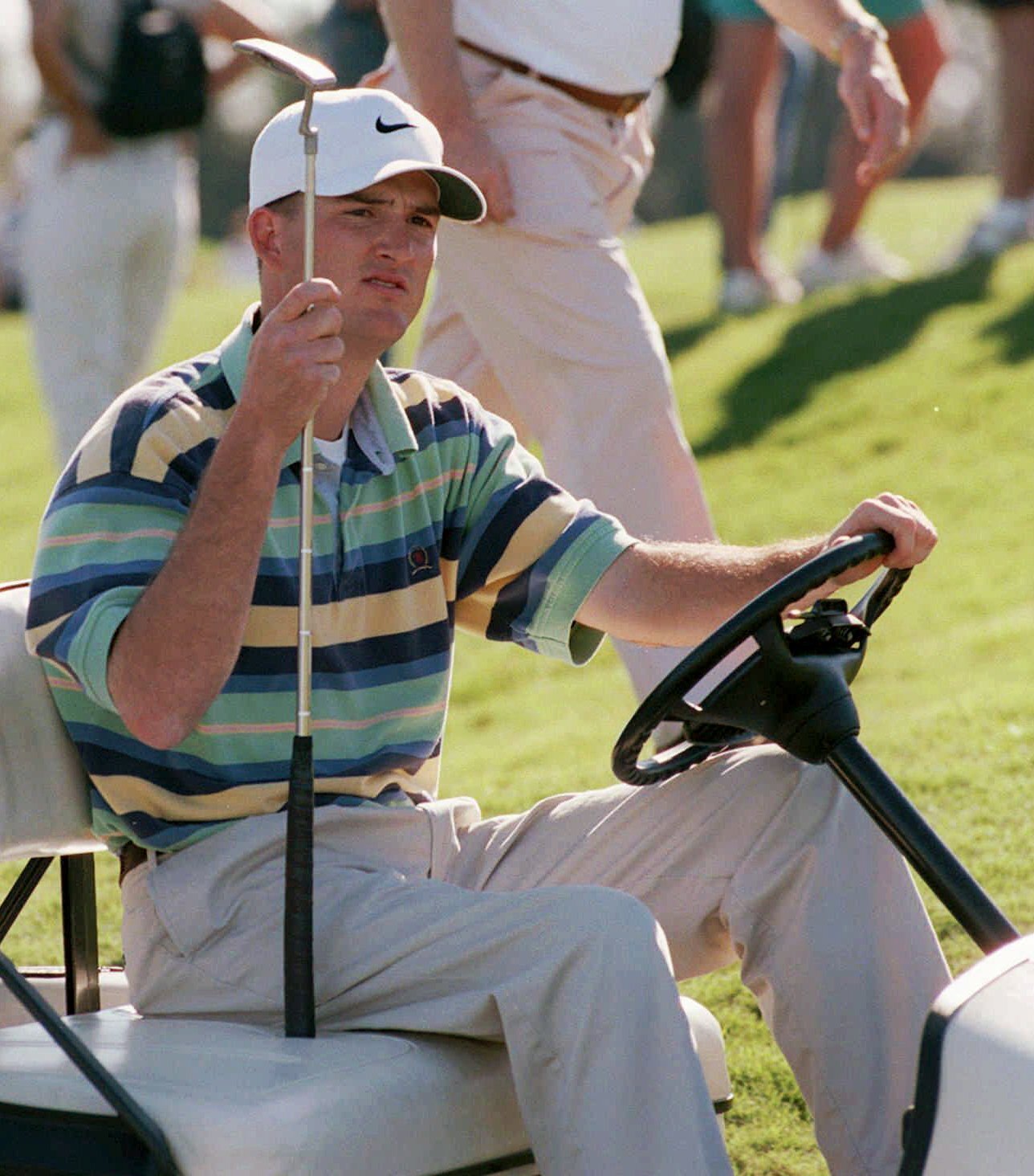 In this Jan. 11, 1998 photo, Casey Martin holds his putter while sitting in a cart after he won the Nike Lakeland Classic at Grasslands Golf and Country Club in Lakeland, Fla.