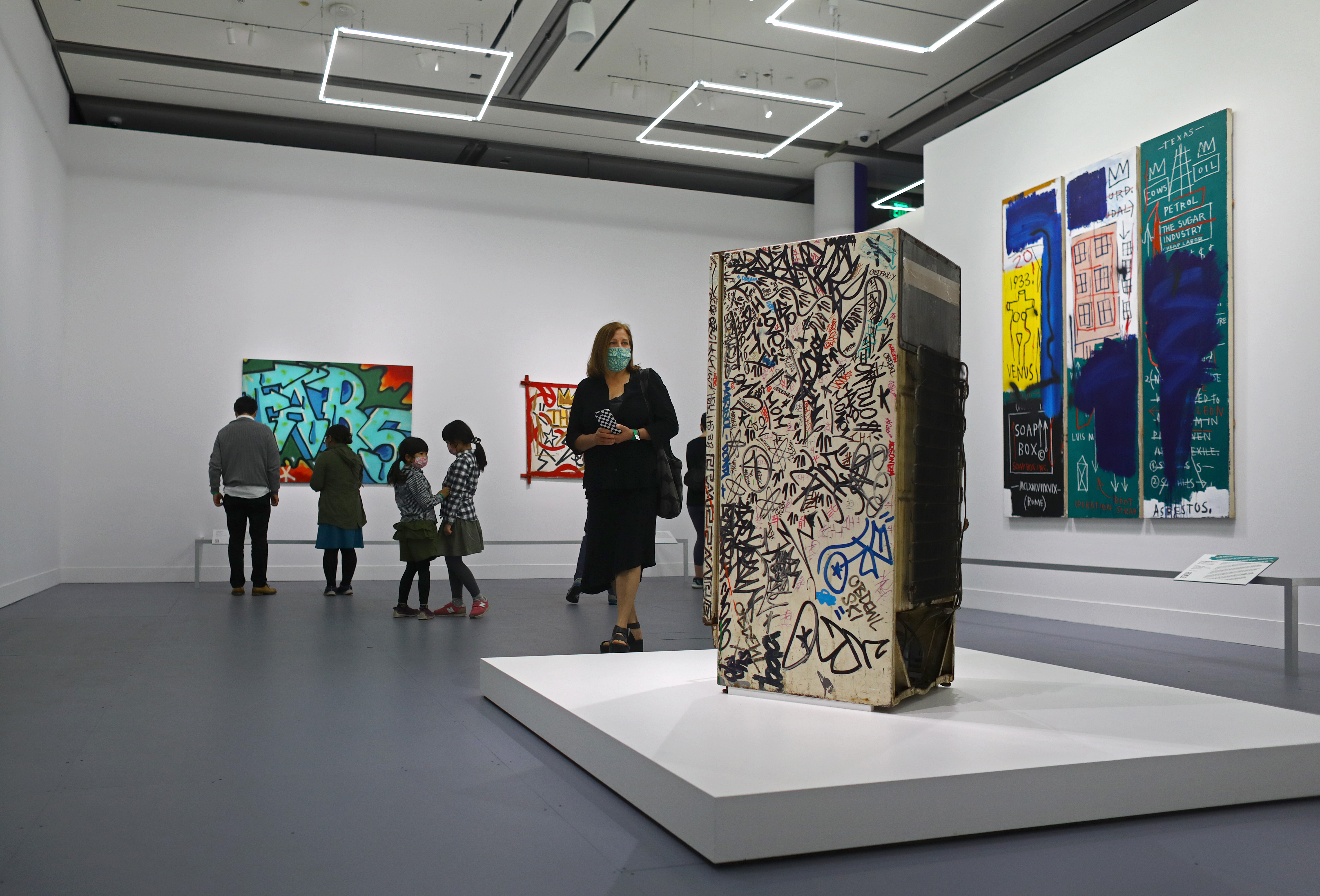 A museumgoer looked over the "Fun Fridge," tagged by Basquiat among countless others.