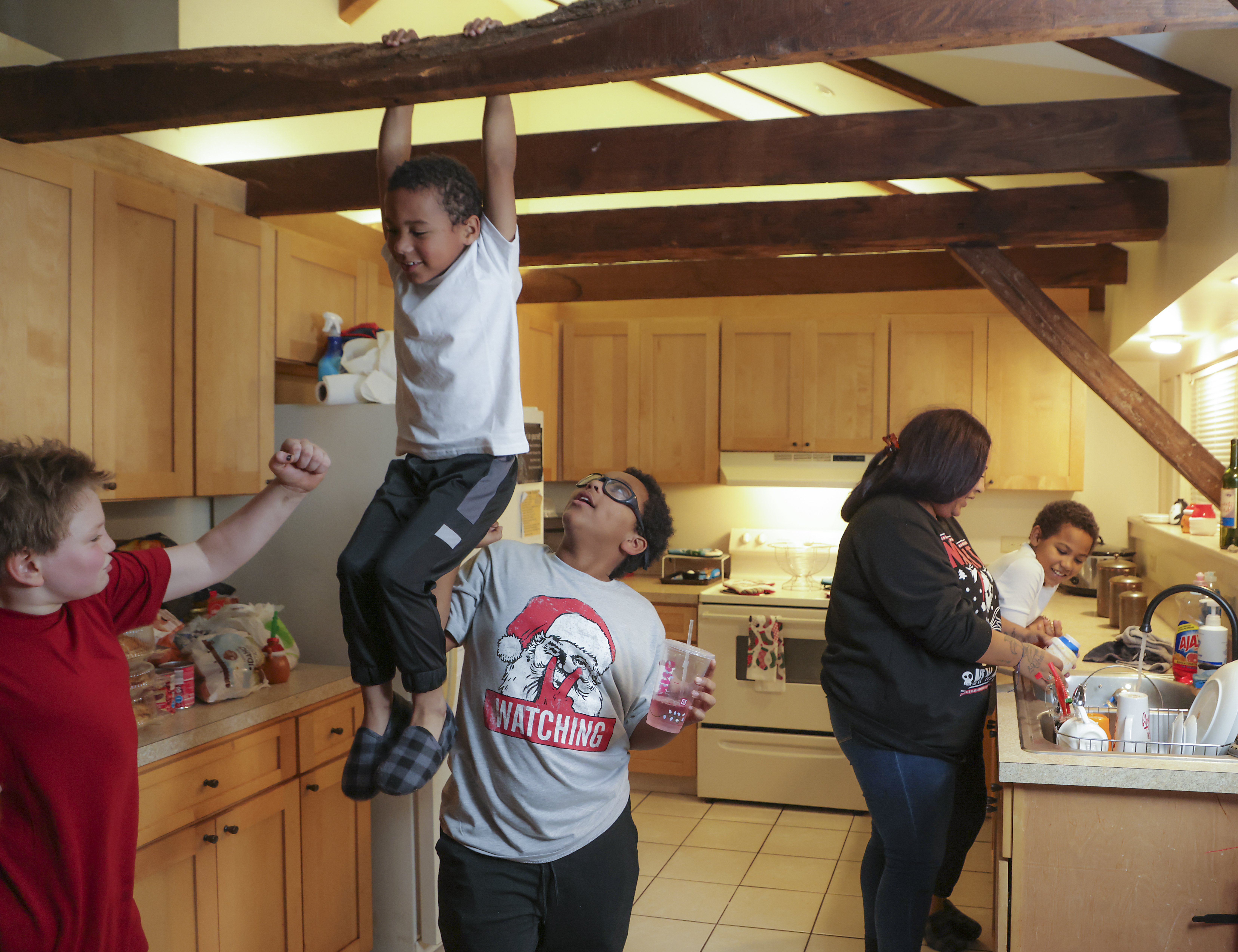 Bryan Lambert, 10, left. a neighbor horsing around with Rafael Ramos Alves, 6, and his brother, Larenzo Fortes, 11, while Jasmine Fortes and her son, Akai Fortes, 8.
