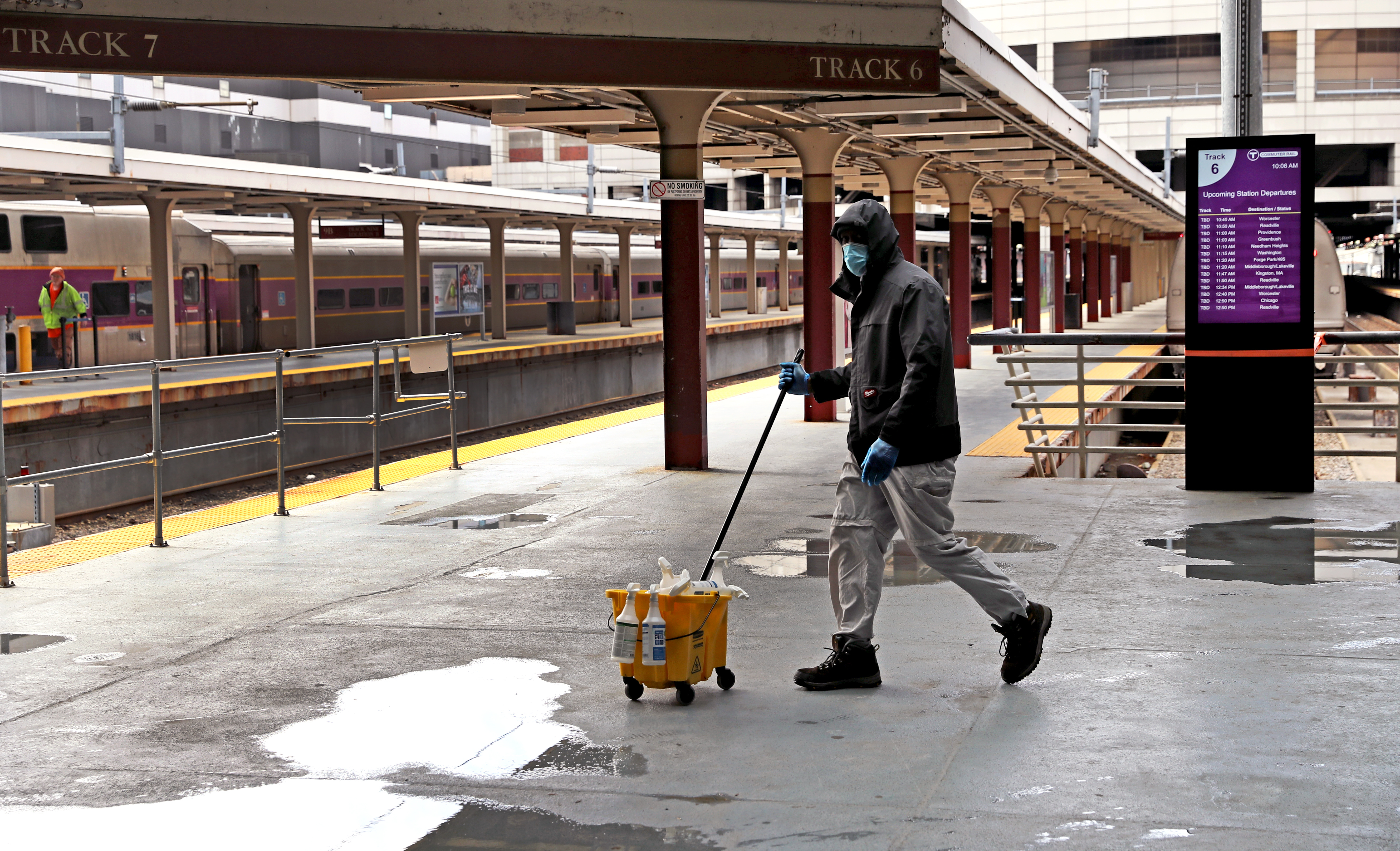 A custodian walked past an empty train platform at South Station.