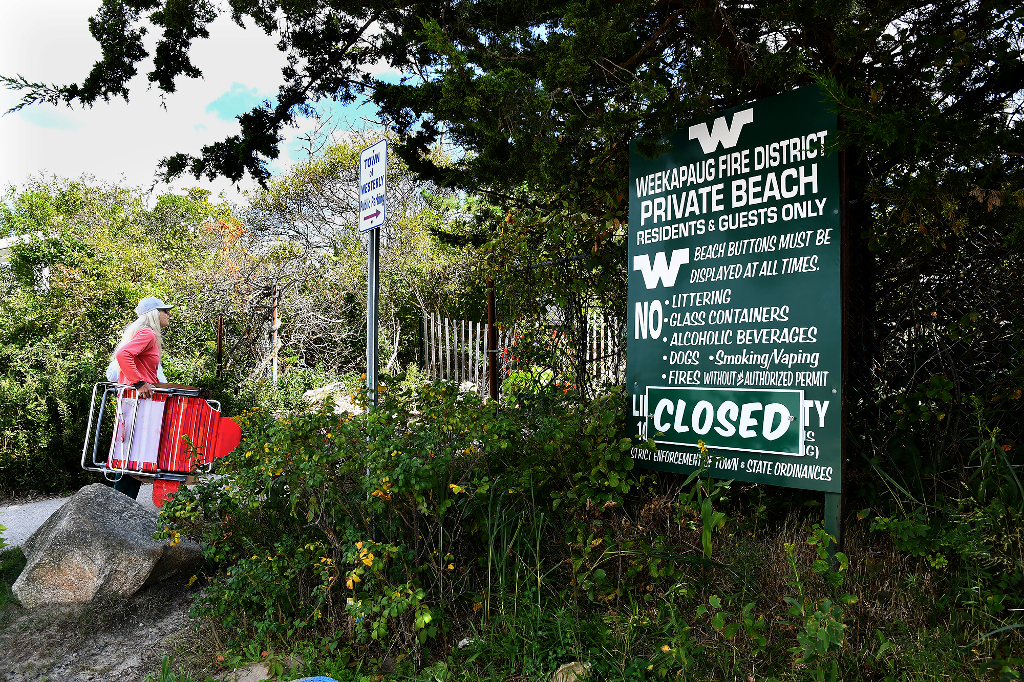 A contested right-of-way or walking path to the shoreline of Block Island Sound in Westerly, RI is blocked by a chain link fence. A boardwalk leading to Weekapaug are for private residents only and not the public during the summer beach season. Opponents Ben Weber, Michael Rubin and Stephen Cersosimo are fighting the lack of access to the state beaches.
