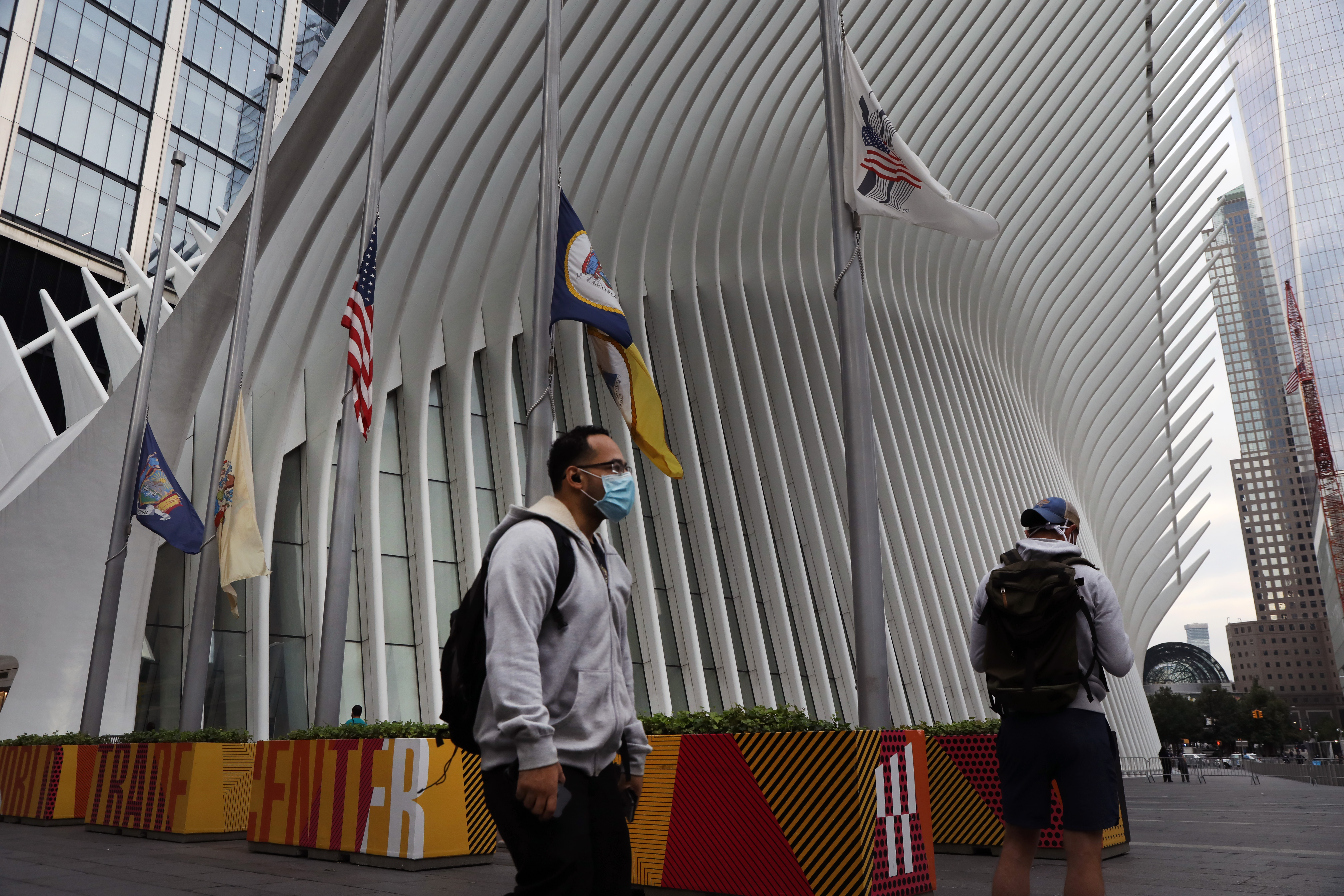People walk by One World Trade Center, the Freedom Tower, which stands at Ground Zero in lower Manhattan as people prepare to commemorate the Sept. 11, 2001 terror attacks in New York City.