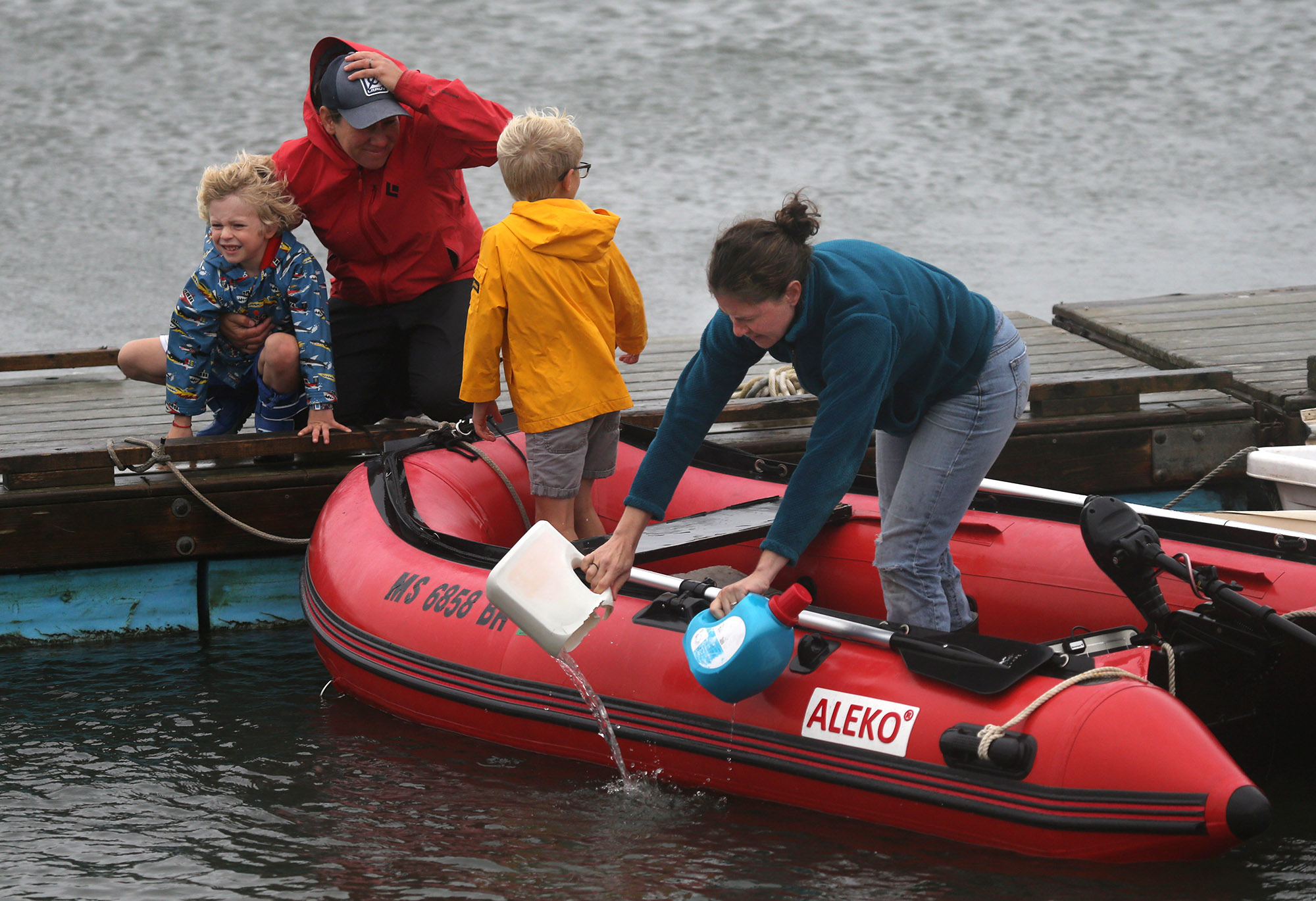 The Kukulya family bailed out their boat in Green Pond in East Falmouth.