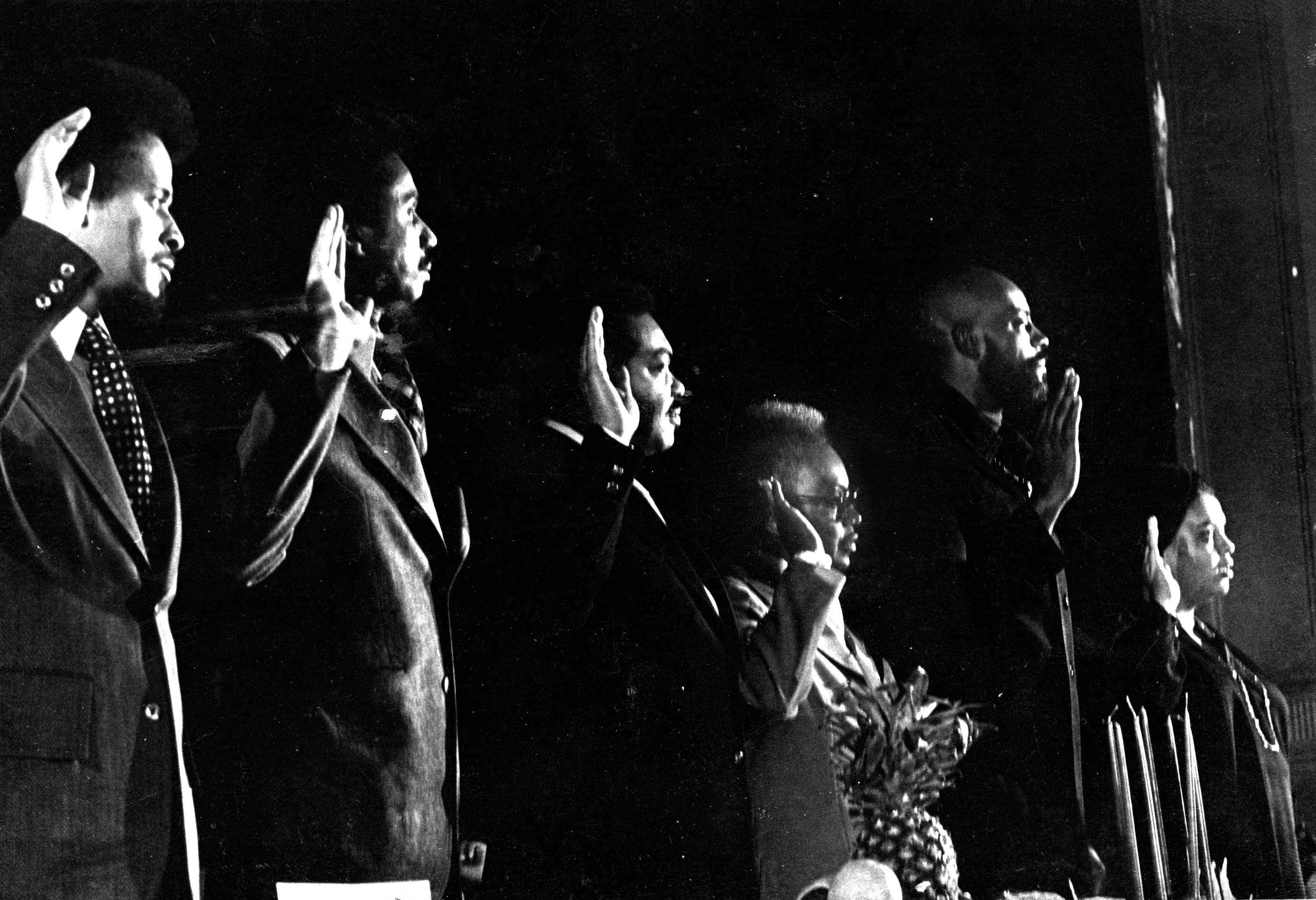 From left, Massachusetts State Representative Royal Bolling Jr., Representative Robert Fortes, State Senator Bill Owens, Representative Mary Goode, Representative Mel King, and Representative Doris Bunte swore an oath to fight for the Black community's right to self-determination and improvement at the Elma Lewis School in Boston's Roxbury neighborhood on Jan. 1, 1977.