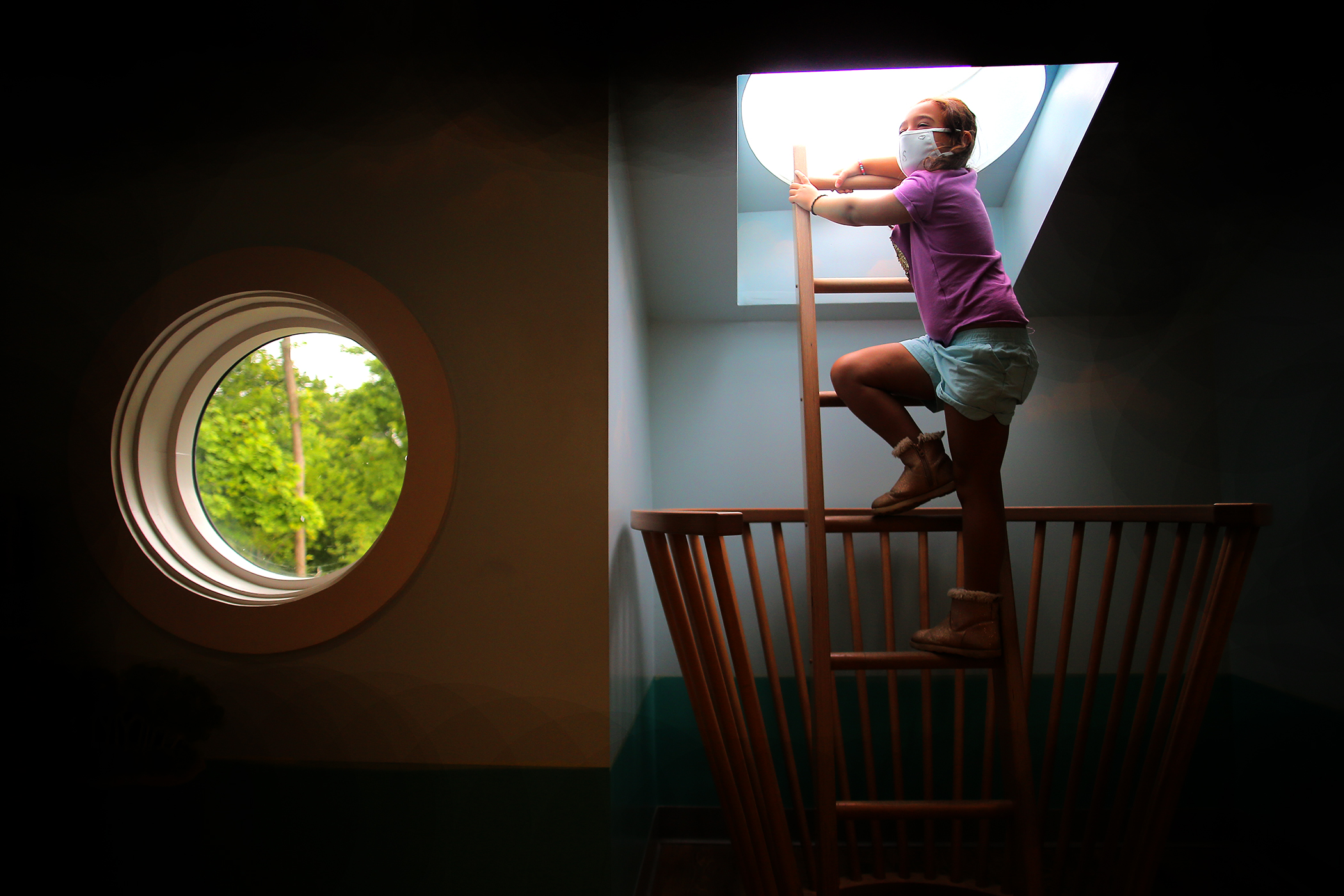 Elle Stamper, 7, climbs into a lookout at the Discovery Museum.