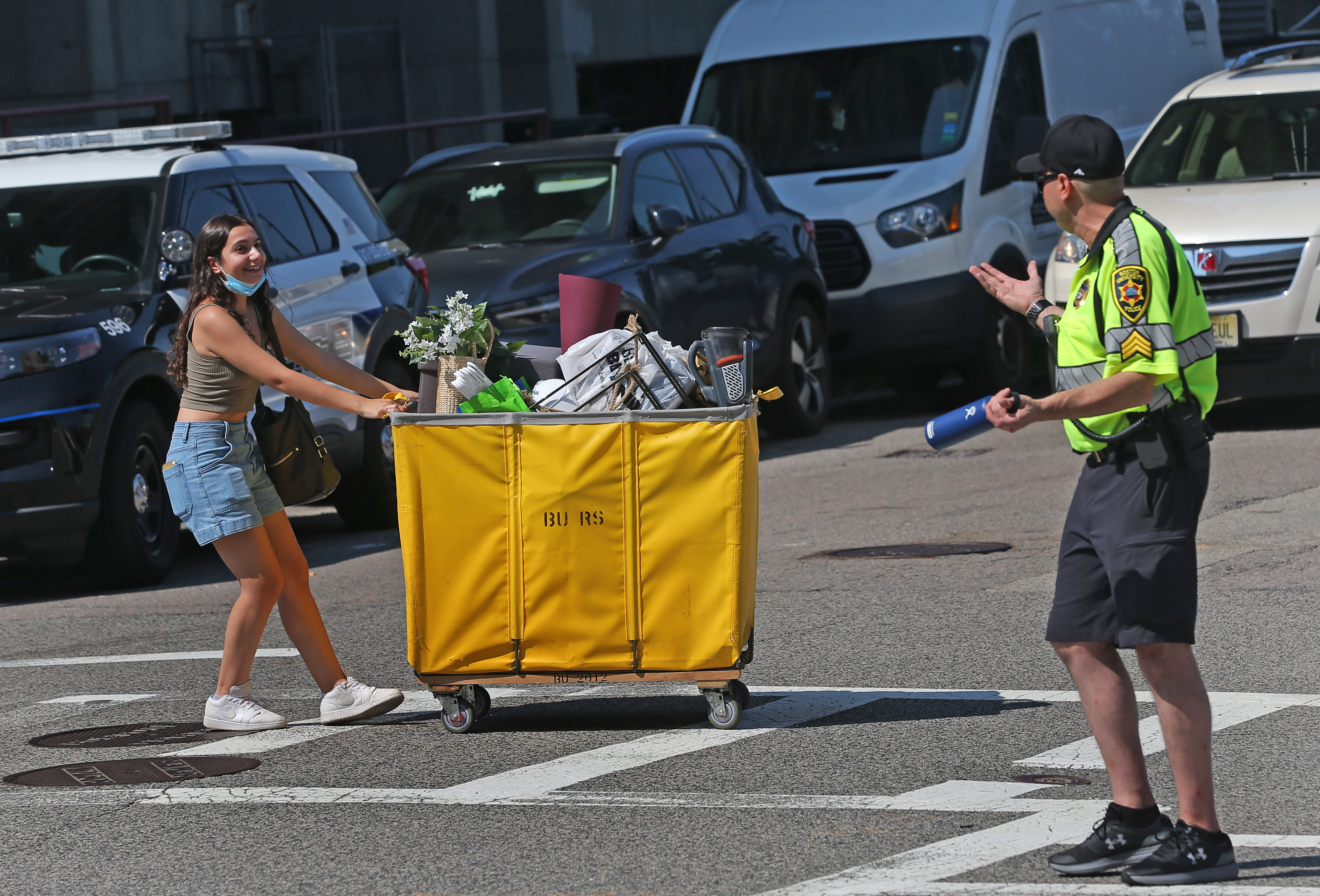 BU sophomore, Dani Nadira of Methuen, talks with BU police sergeant Mike Vanaria during move in day at Boston University.