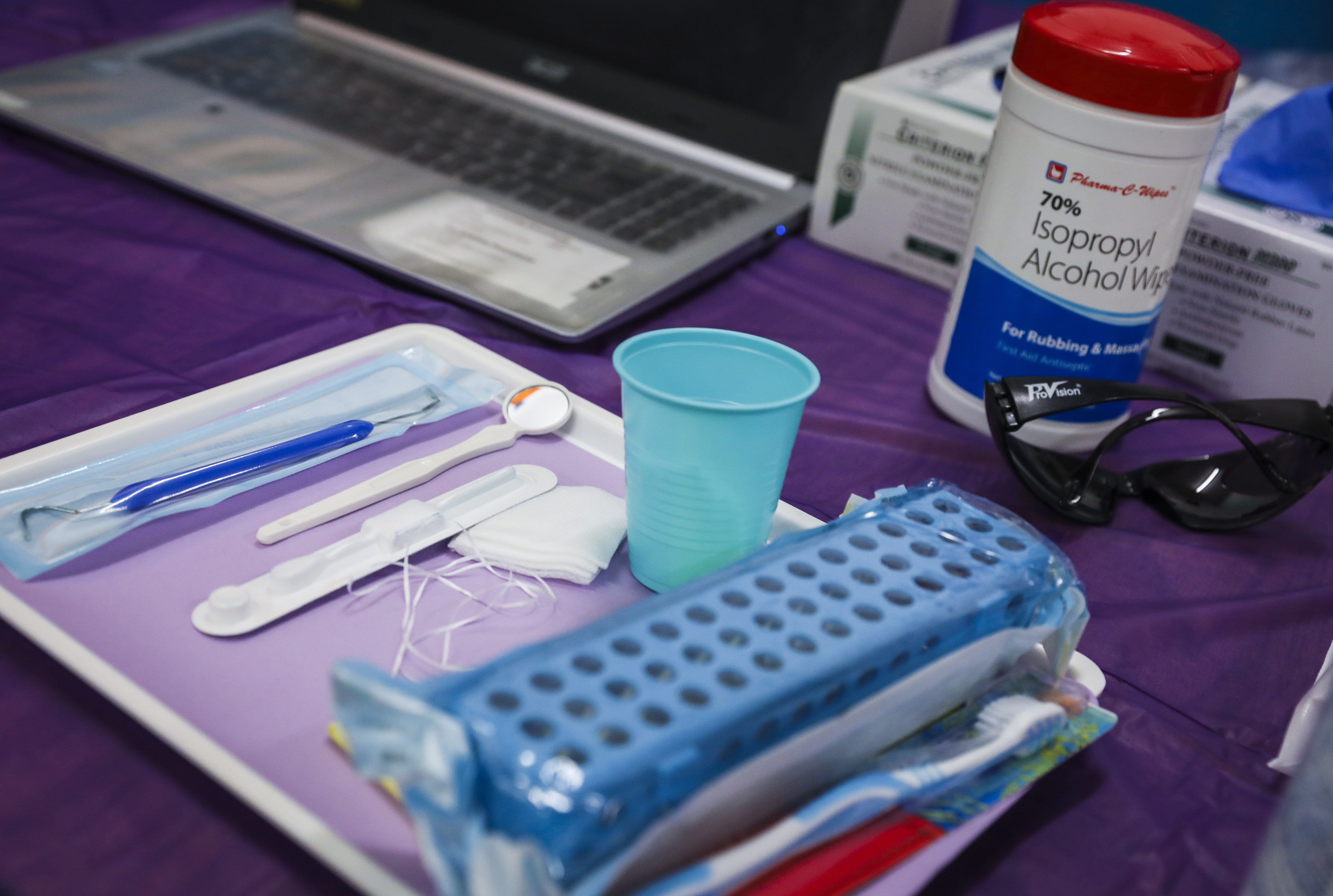 A container of alcohol wipes rested next to a tray of dental tools at a pop-up dental program created by ForsythKids.