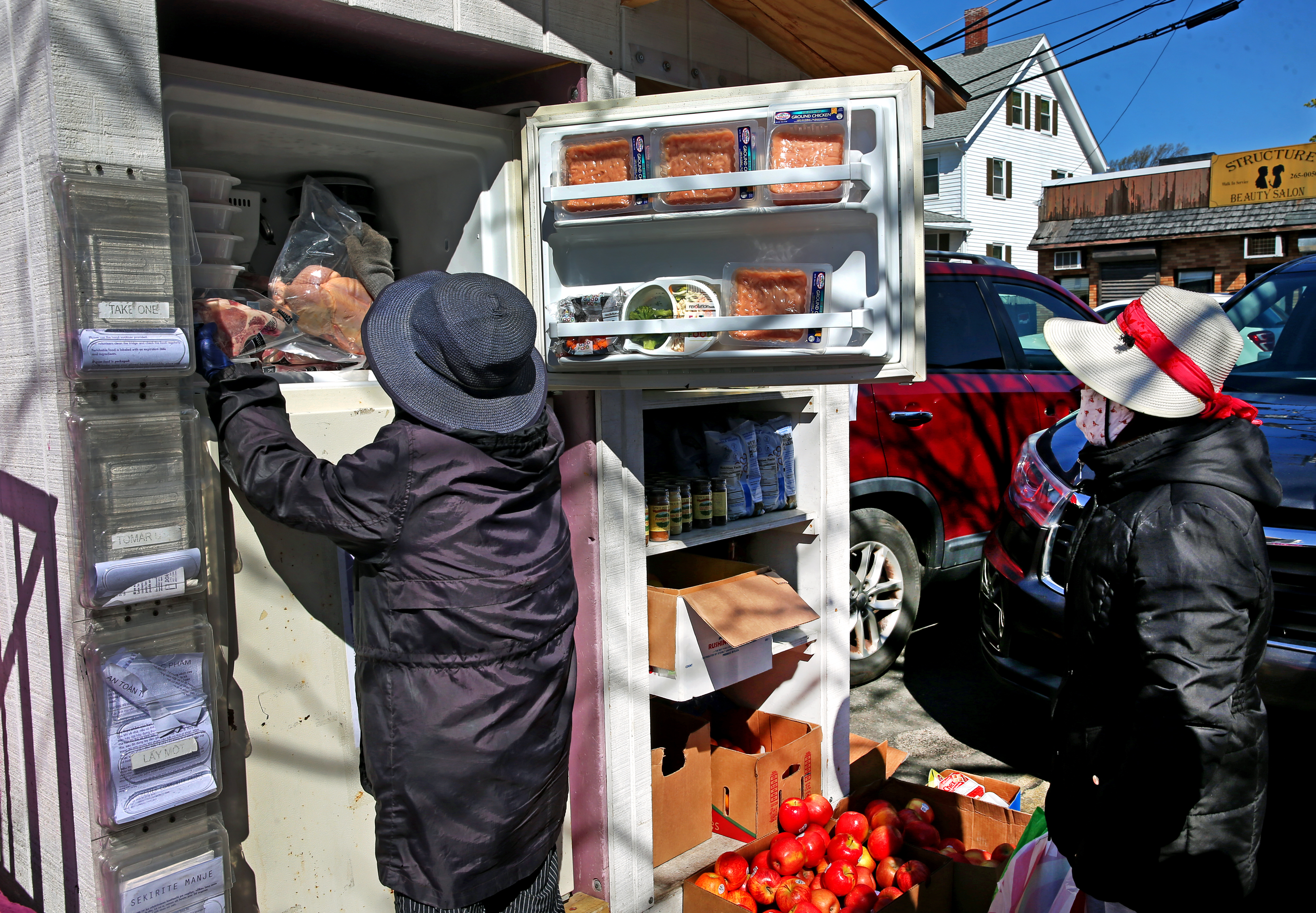 Those in need took free food from a community fridge near the Red Line MBTA train tracks in Fields Corner.