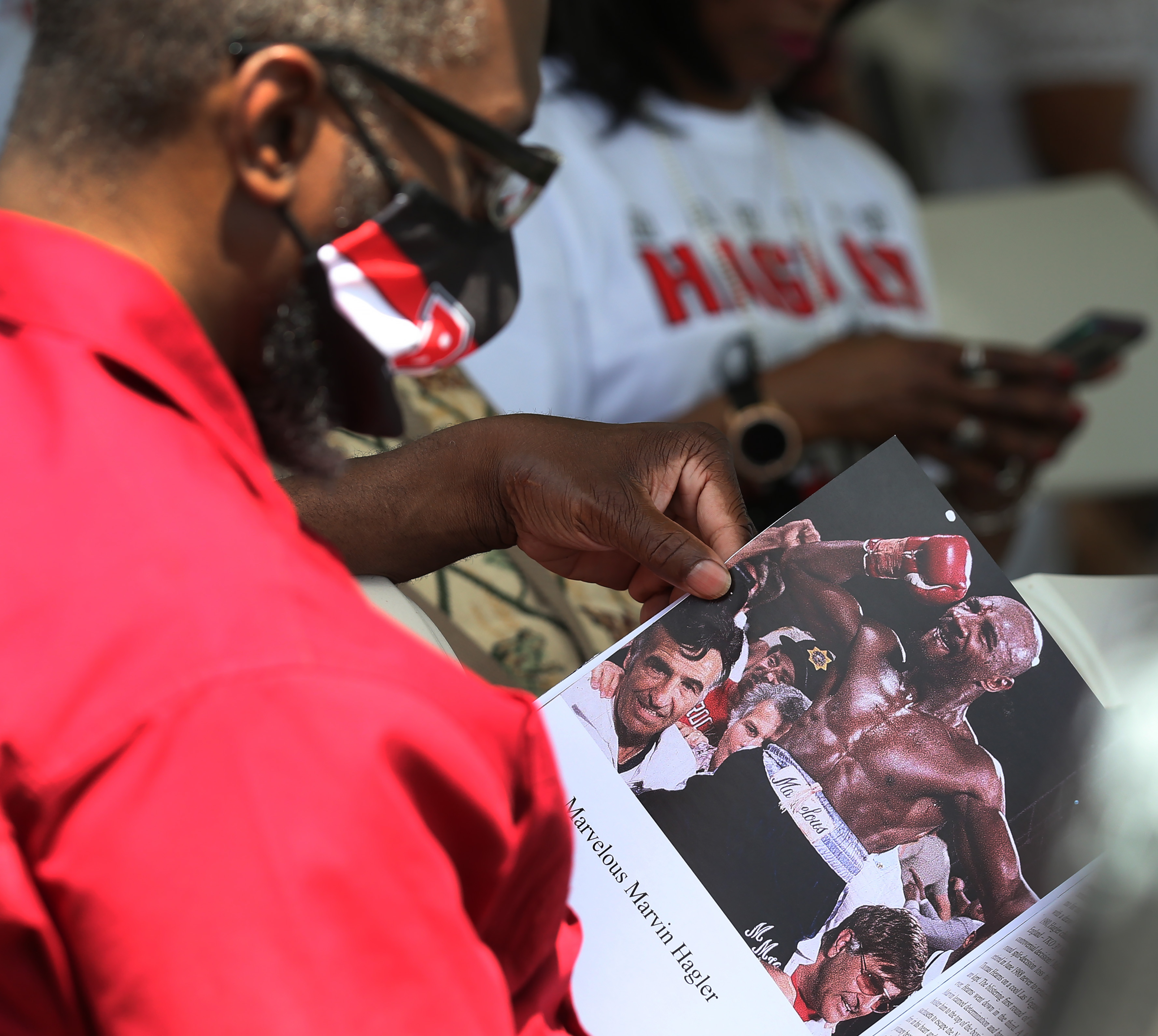 An attendee looked at a commemorative book that was part of the "Marvelous Marvin Hagler Day" celebration at Rocky Marciano Stadium in Brockton on Sunday.