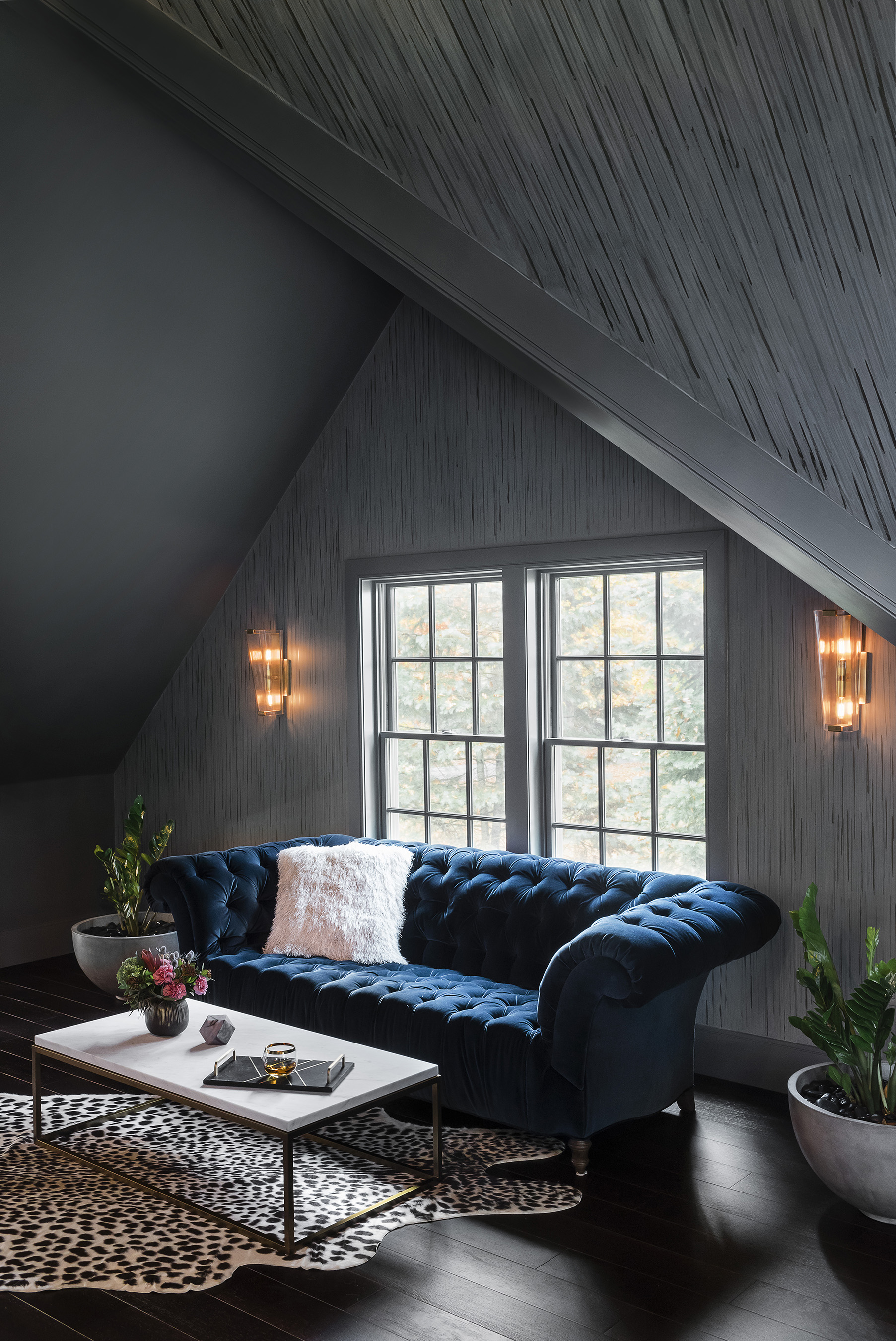 Pauline Curtiss of Patina Designs created a multilayered, patterned paint treatment for the slanted ceilings and walls that she says is “like sound dancing around the walls.” Robins upholstered the Schumacher sofa in performance velvet so even red wine spills aren’t a problem.