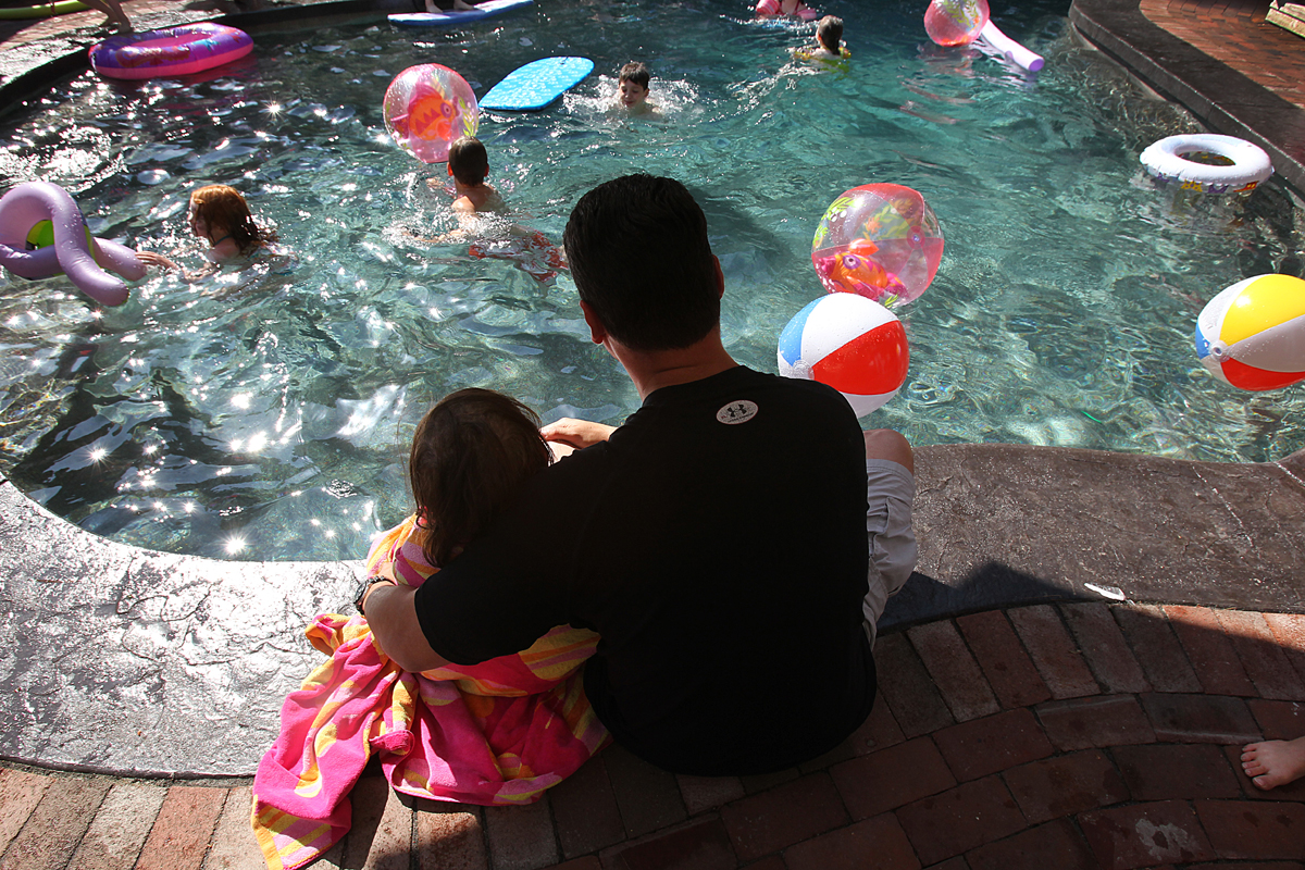 Caroline and her father, Kevin, rested at an early sixth birthday party for her in June. The family held out hope for a miracle, but worried she might not live to her real birthday.