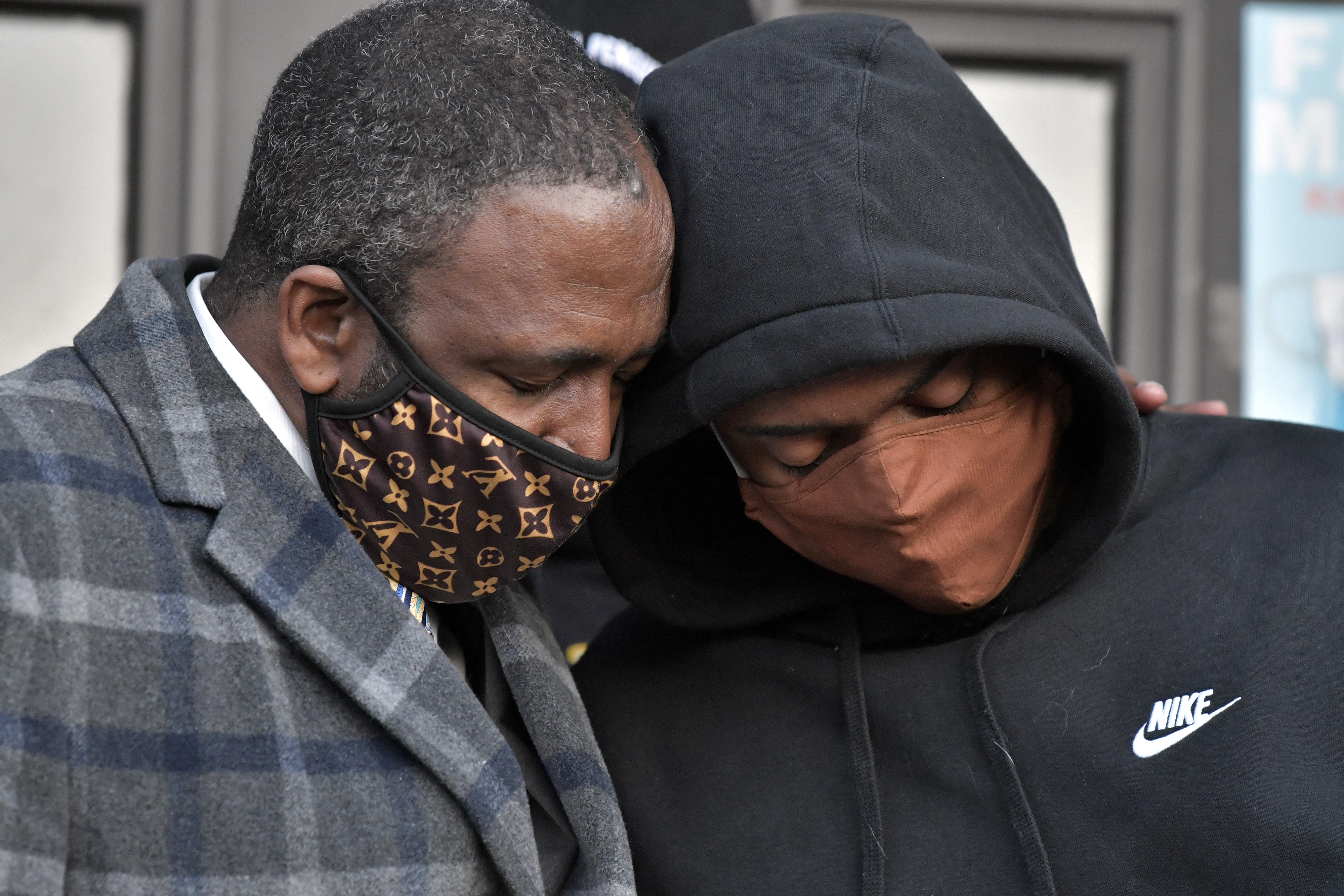 Donald Osgood (left), whose son played basketball with Terrence Clarke, and former Clarke teammate Julian Howell, 21, of Dorchester console each other during a candle lighting ceremony which was attended by more than two hundred members of the community.