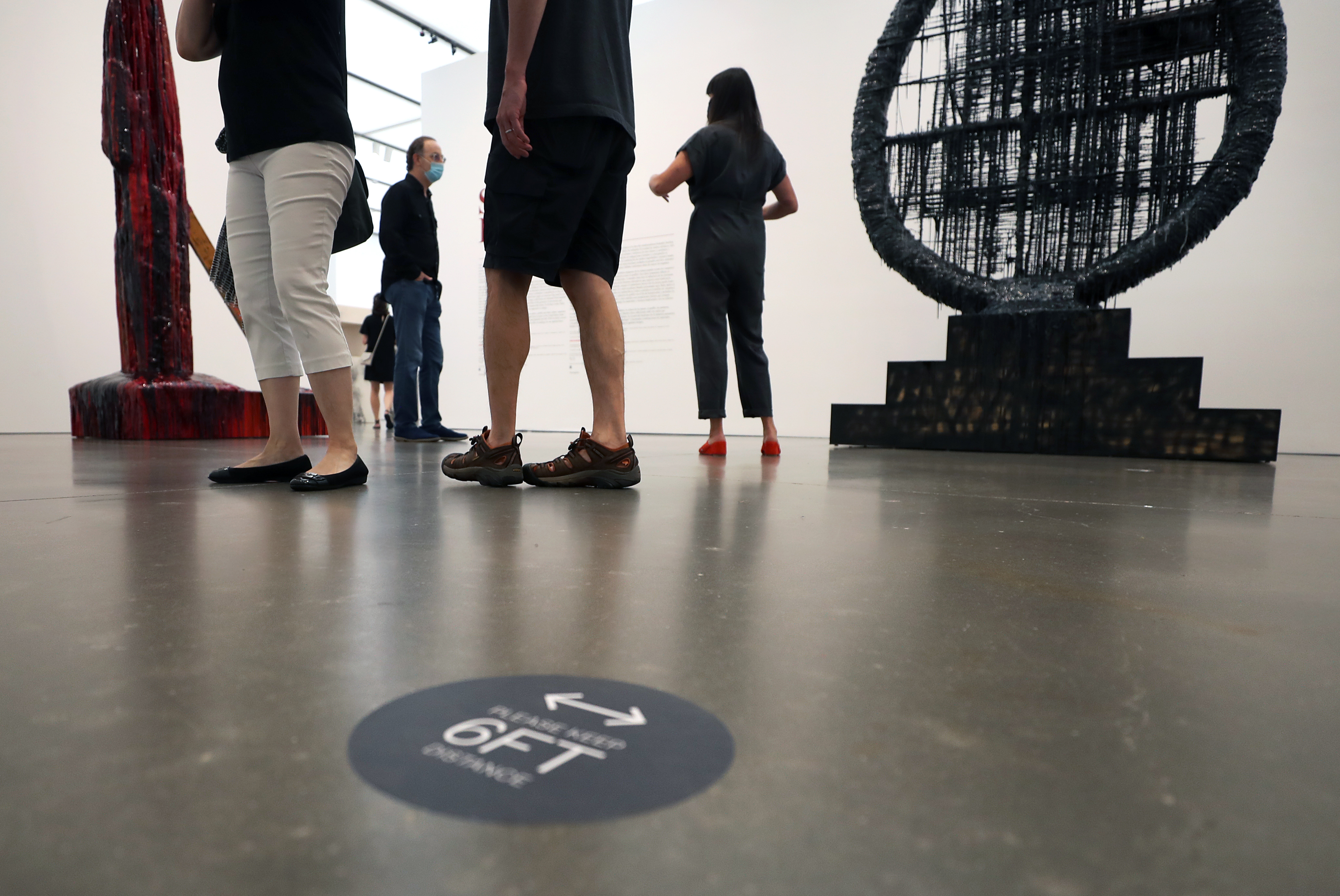 The first few people to enter the ICA on Tuesday stood among the social distancing signs placed on the floor.