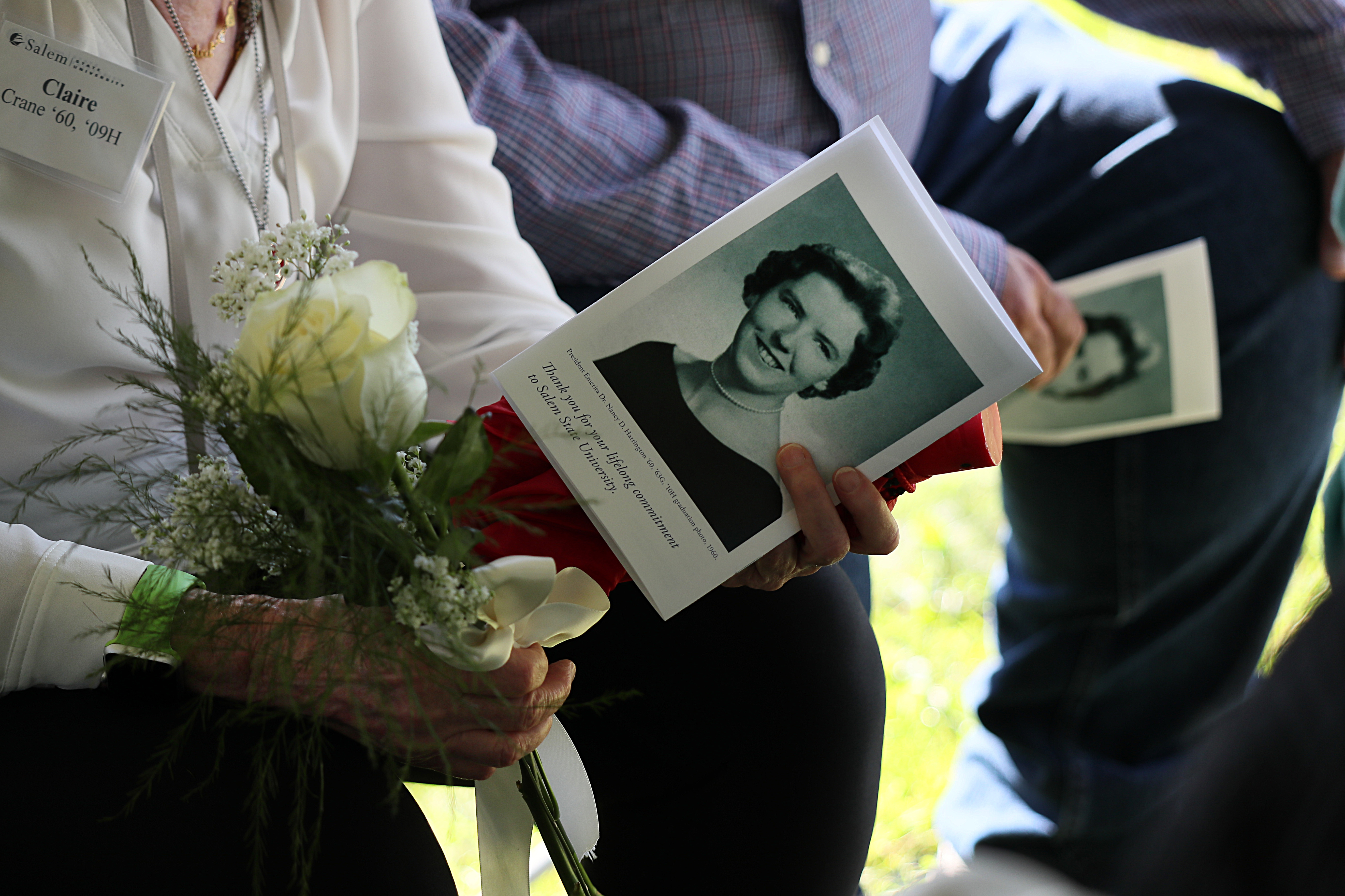 Members of the 1960 class received white roses in honor of their classmate, Nancy D. Harrington, at the ceremony on Friday. Suzanne Kreiter / Globe staff