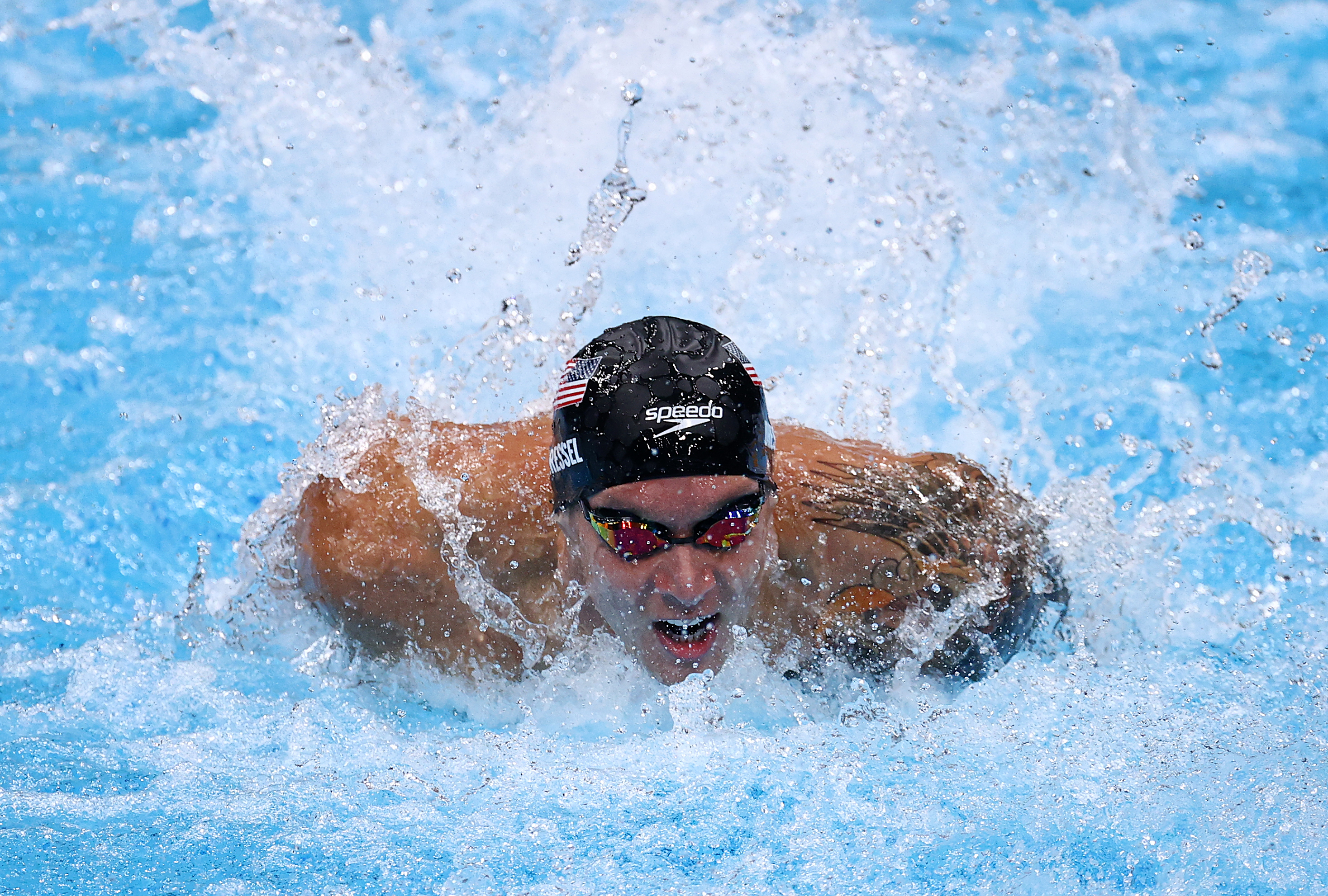 Caeleb Dressel surged to a world record in his 100-meter butterfly win.