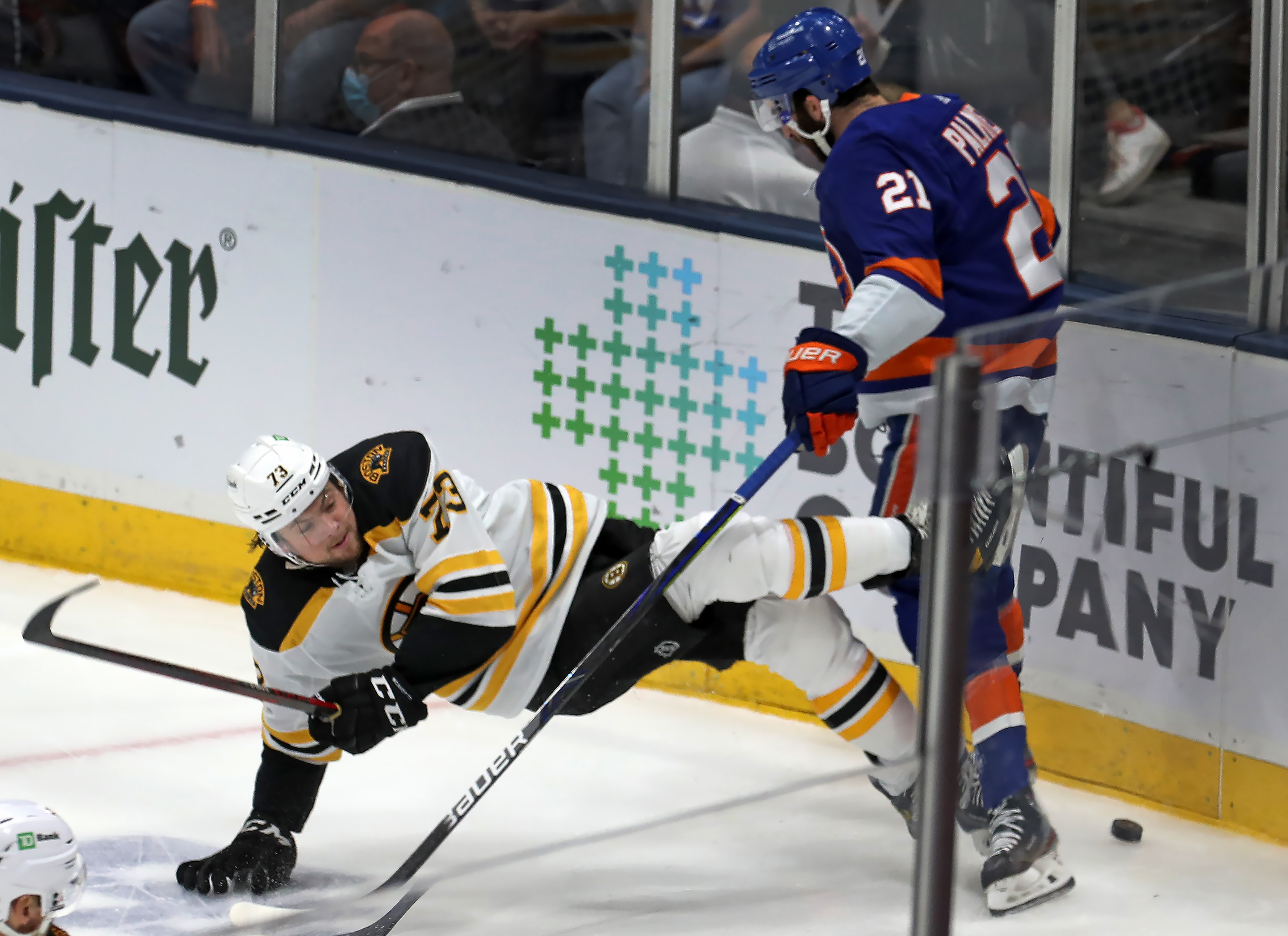 Charlie McAvoy gets the worst of this first-period puck battle with New York's Kyle Palmieri Wednesday night.