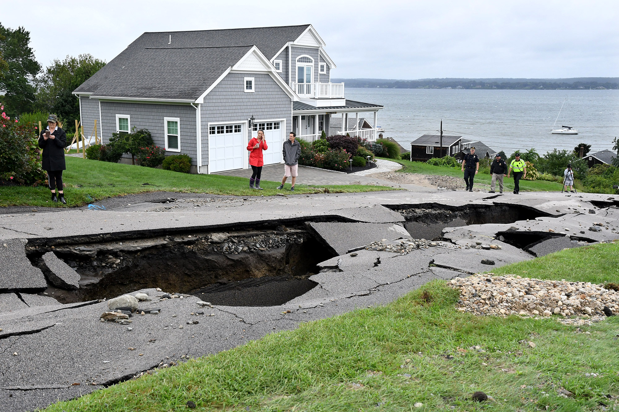 Residents of Fairview Lane came out to view the damage to their road.