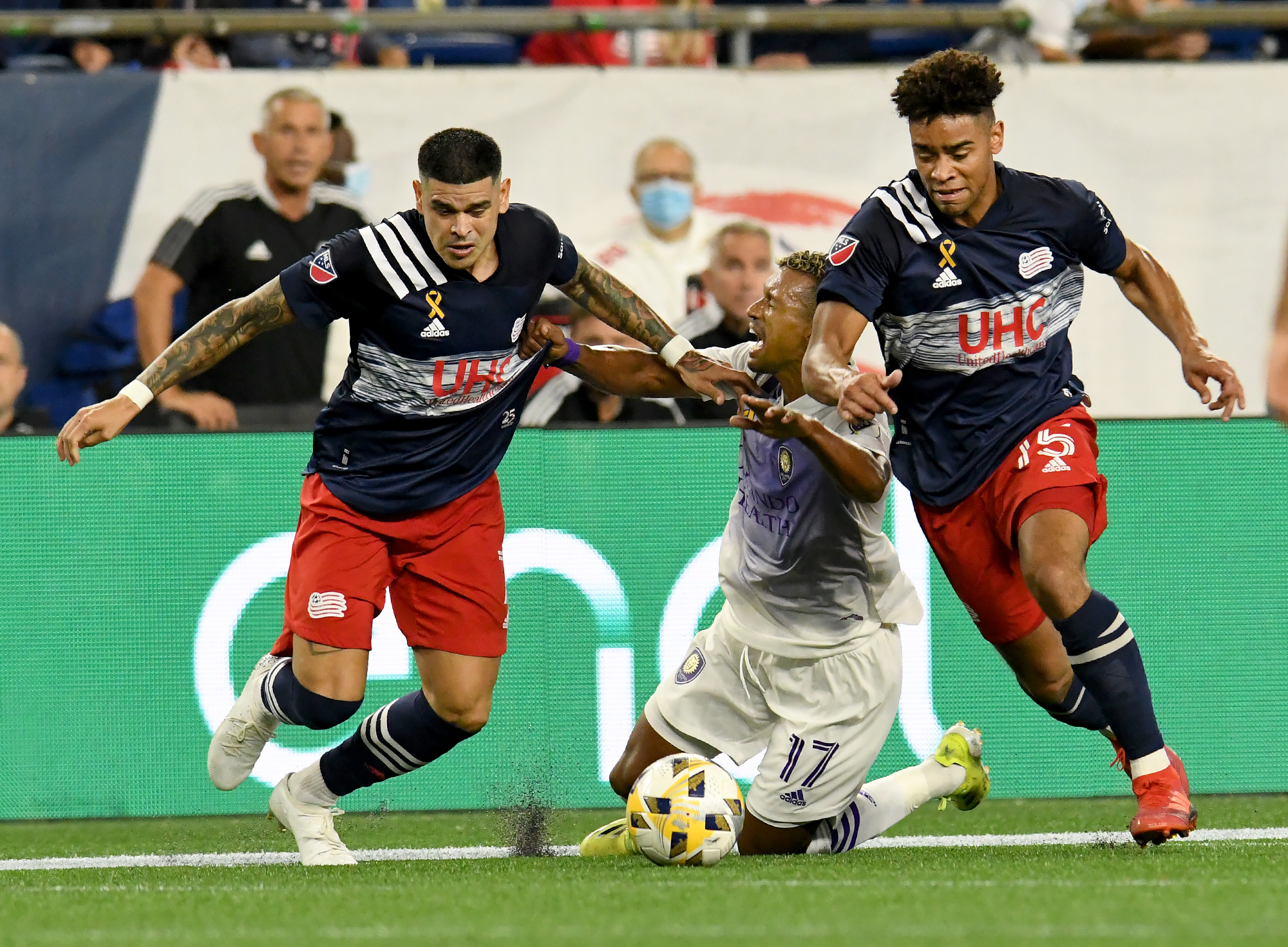 The league-leading Revolution (18-4-5; 59 pts.) were back home at Gillette Stadium against fourth-place Orlando City SC. Gustavo Bou, (left), and Brandon Bye trip up Orlando's Nani.