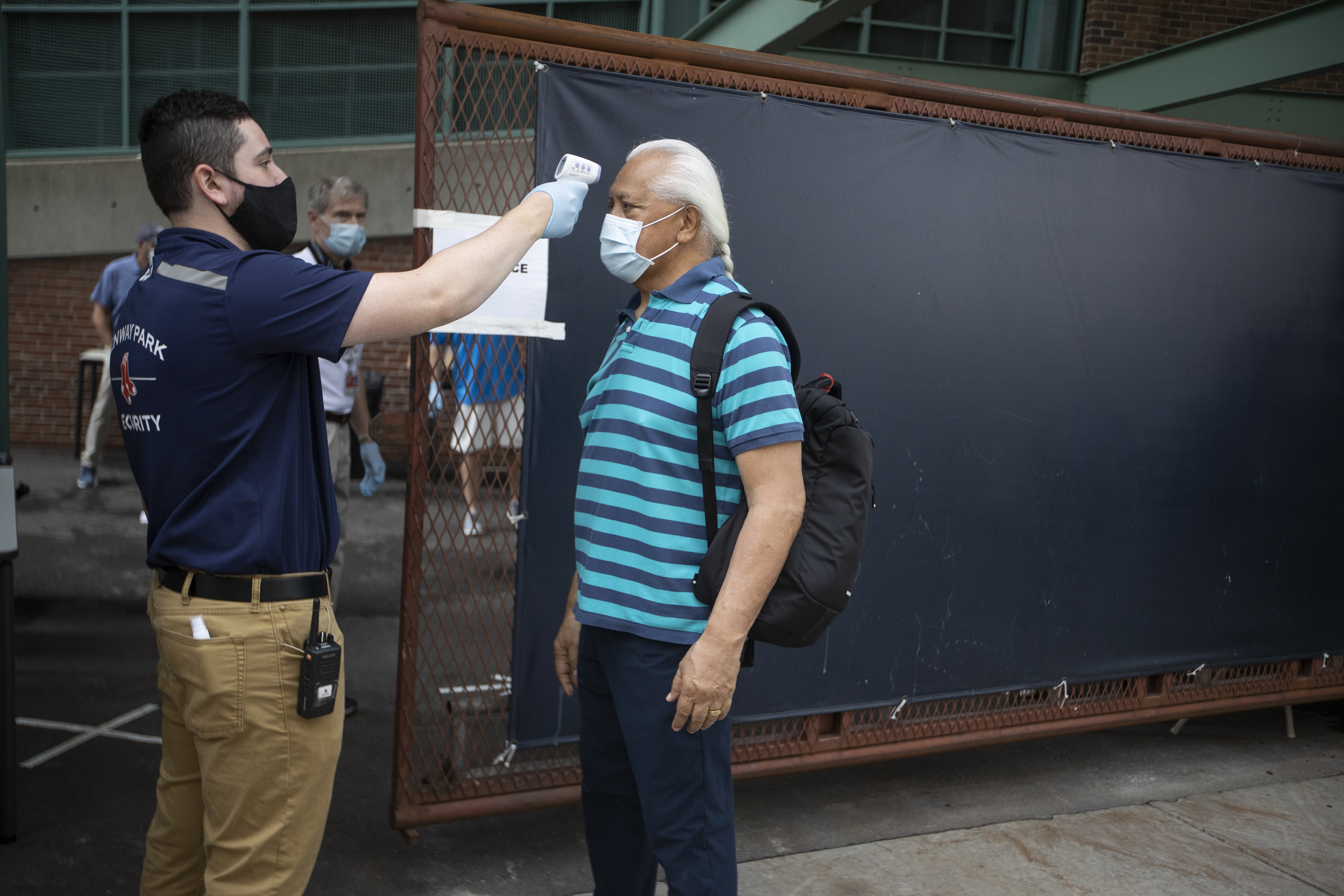 Red Sox massage therapist Russell Nua has his temperature taken before entering Fenway Park on Monday.