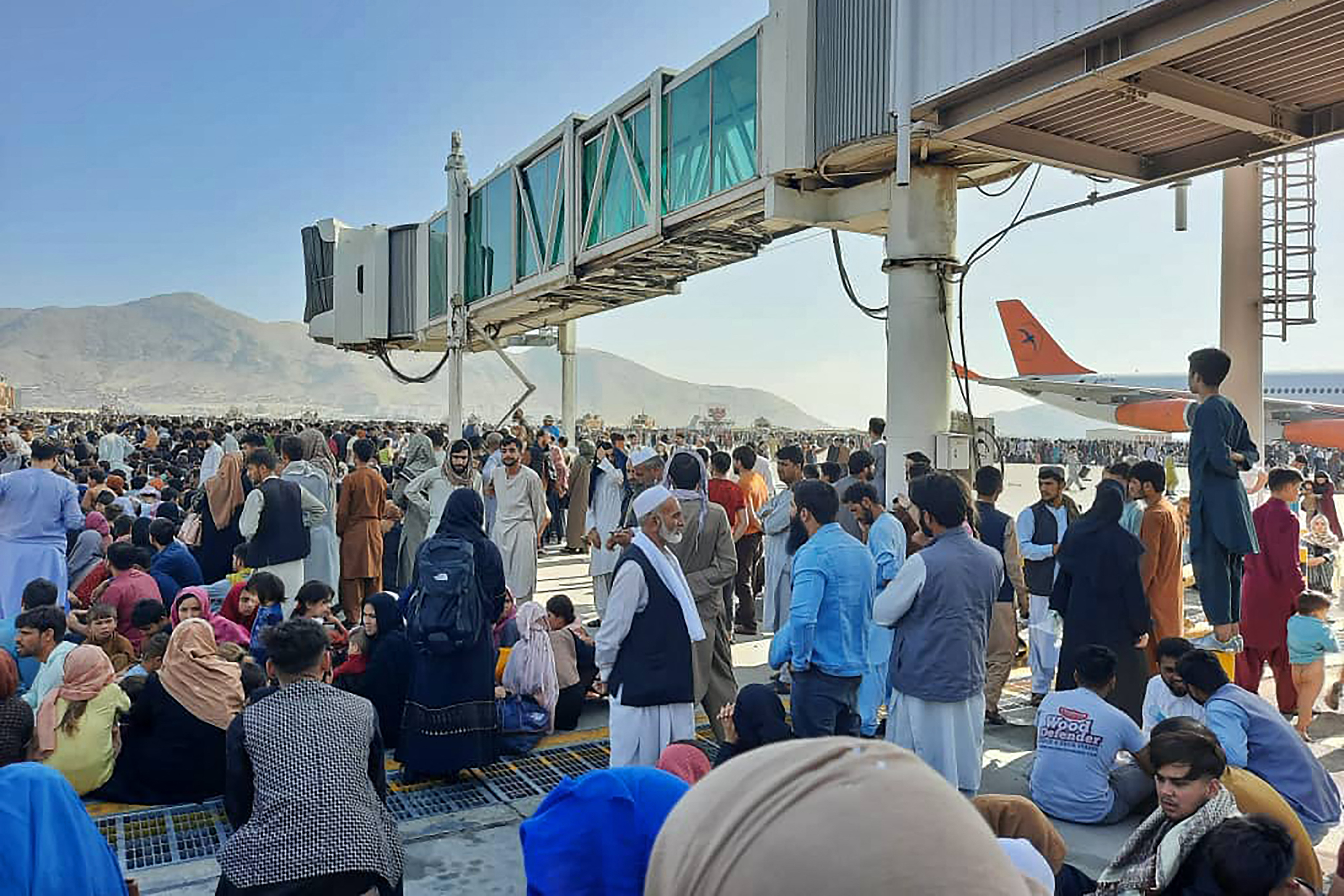Afghans crowded at the tarmac of the Kabul airport.