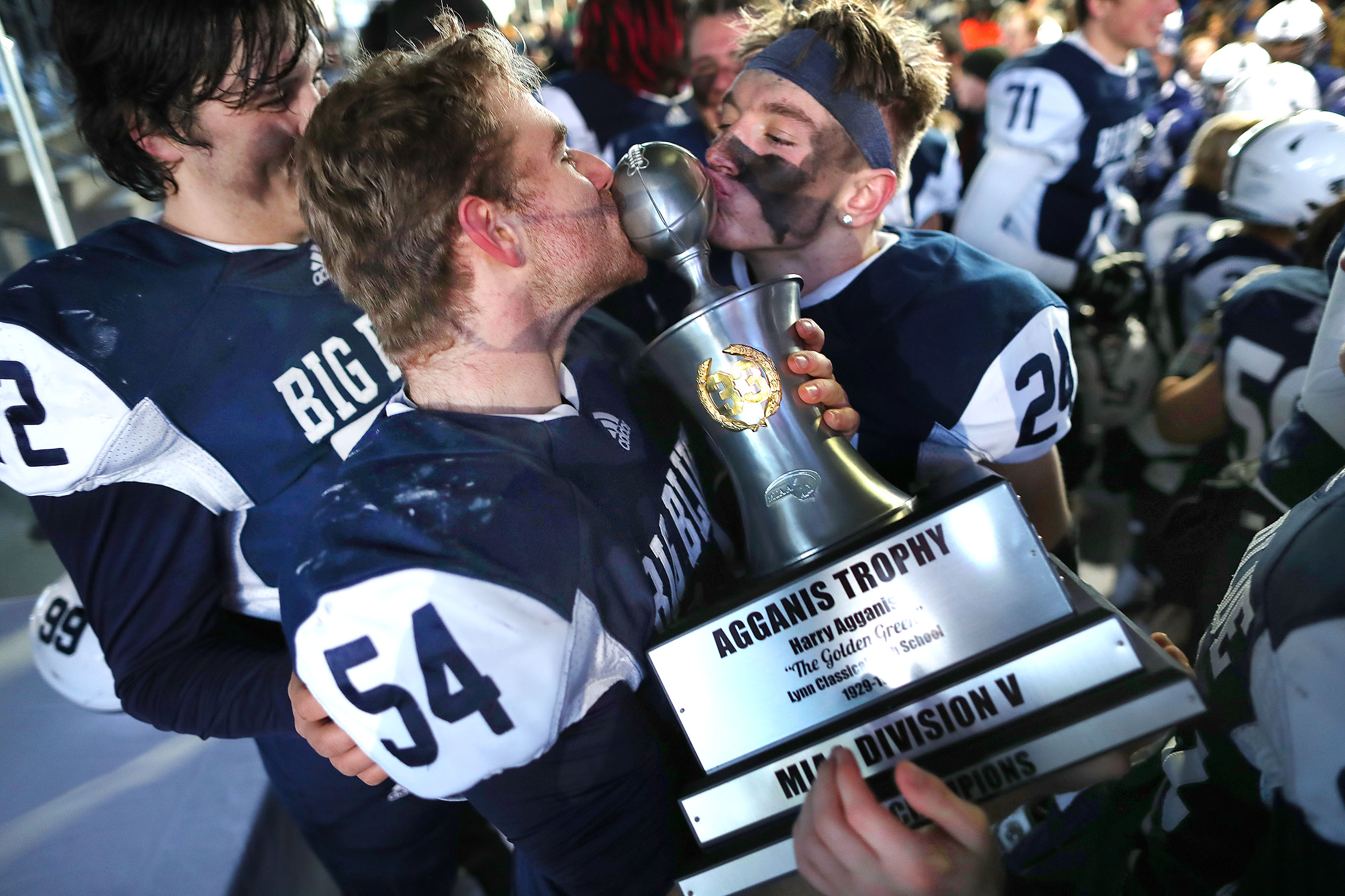 Swampscott’s Nick Reiser (left) and Caden Dubiel kissed the Agganis Trophy after defeating Amherst-Pelham in the Division 5 Super Bowl at Gillette Stadium in Foxborough on Dec. 7.