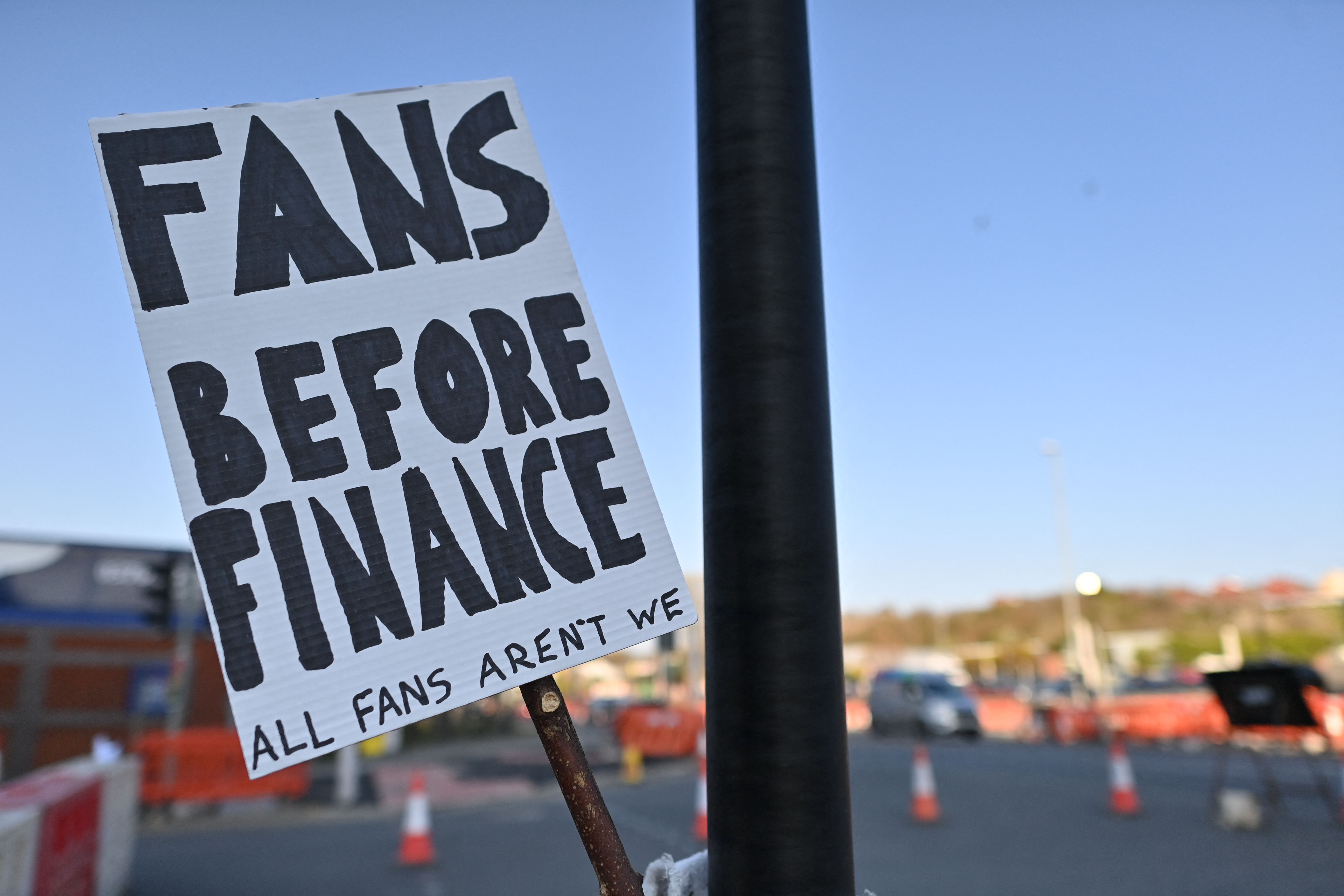 A picture shows a placard with a message against plans for a European Super League outside Elland Road ahead of the English Premier League football match between Leeds United and Liverpool on Monday.