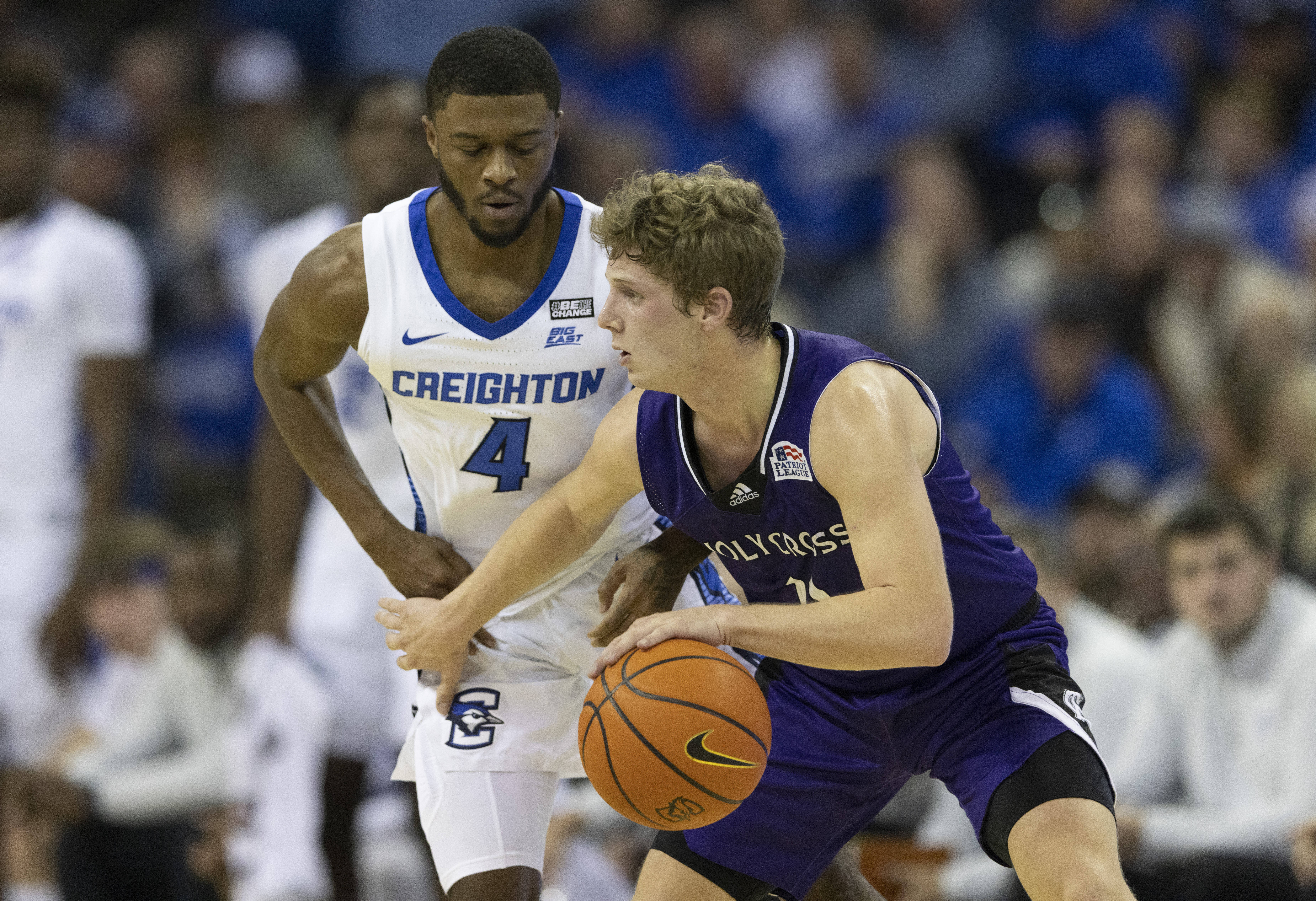 Boston University, Holy Cross basketball players mask up on court